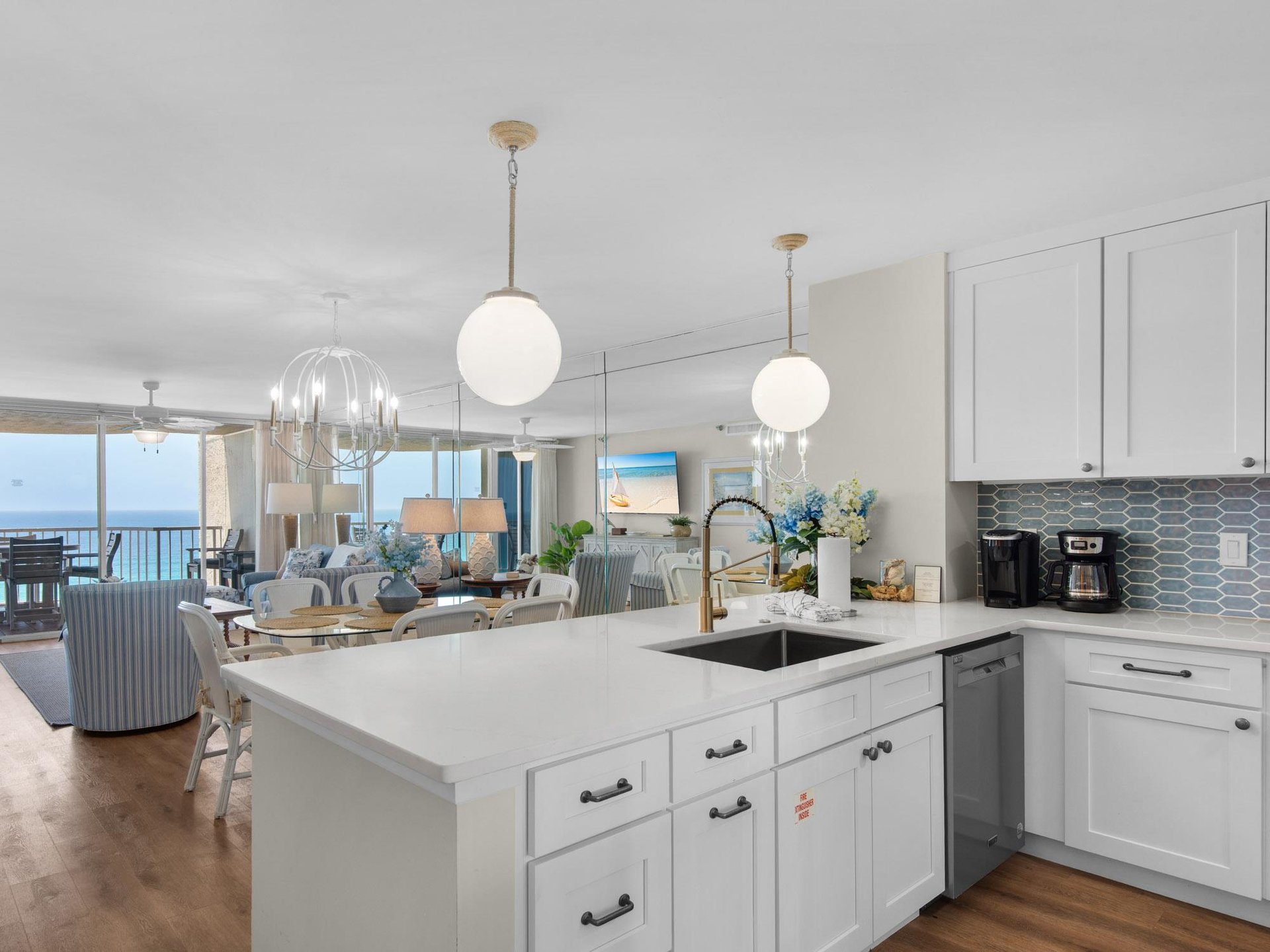 Gourmet kitchen features sleek white cabinetry and modern appliances