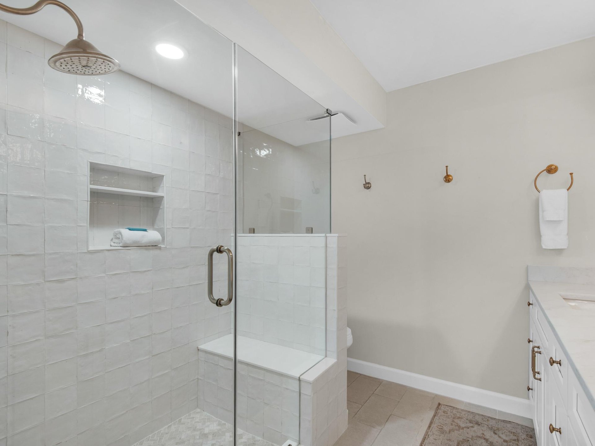 Refresh after a day of adventure in your spacious walkin shower, crisp white subway tile, and a builtin bench for ultimate comfort.
