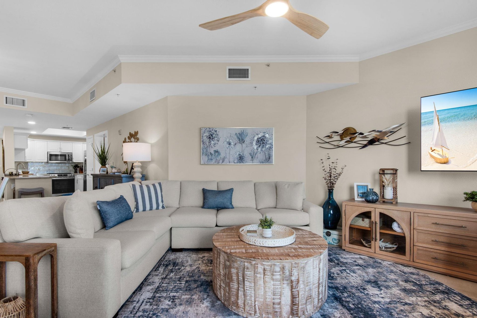 The welcoming living space features plush sectional seating and an open layout.