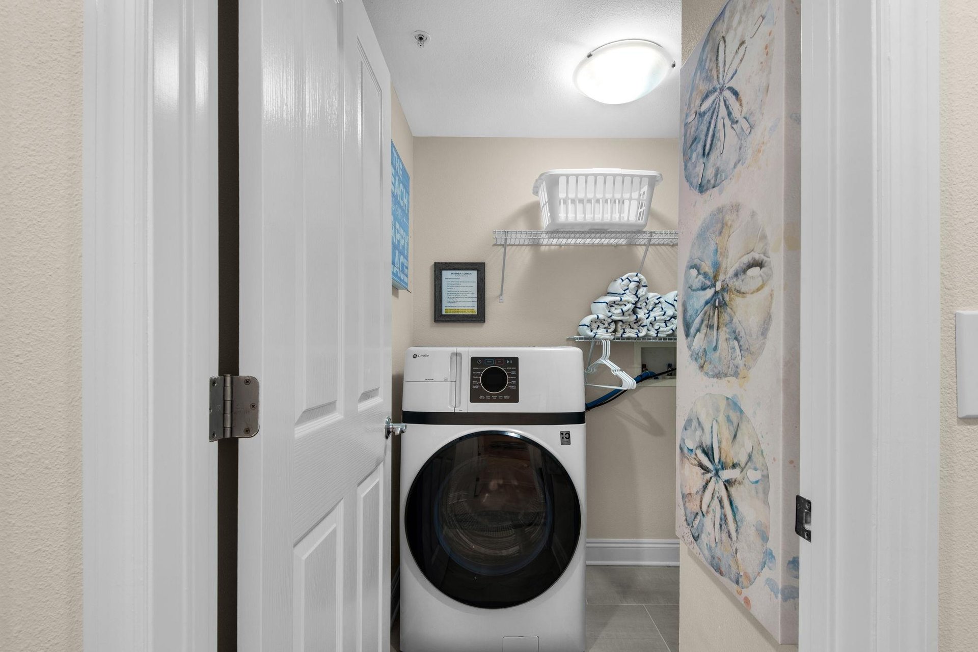A dedicated laundry room features a fullsize washer and dryer