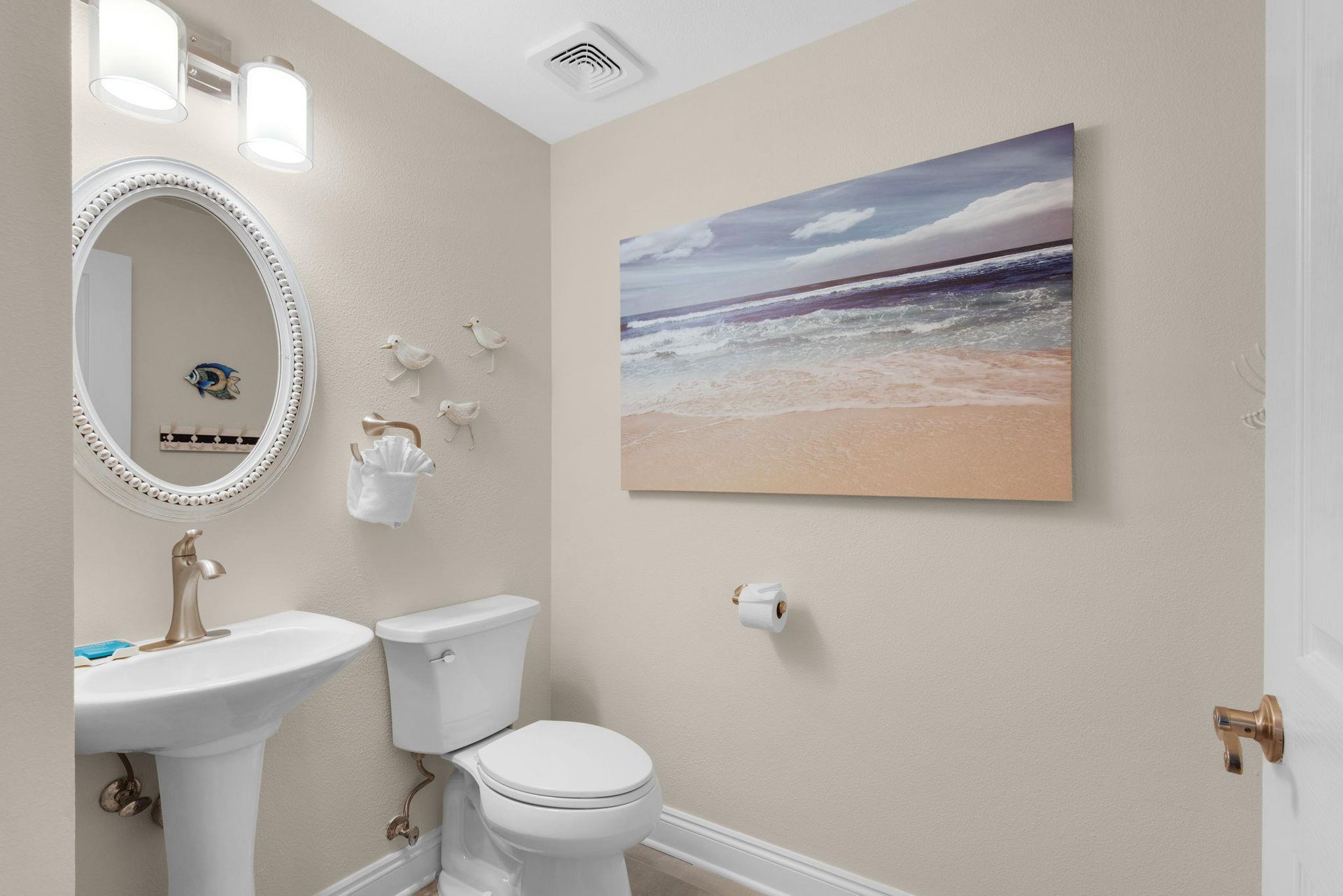 The convenient powder room with a pedestal sink
