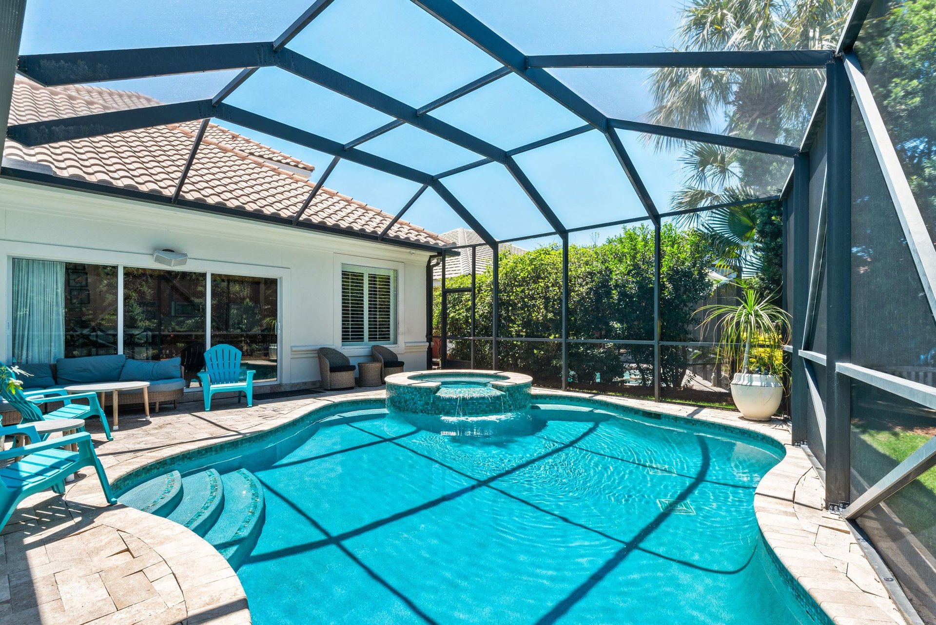take a refreshing dip in your private screened pool, then relax on the sun loungers