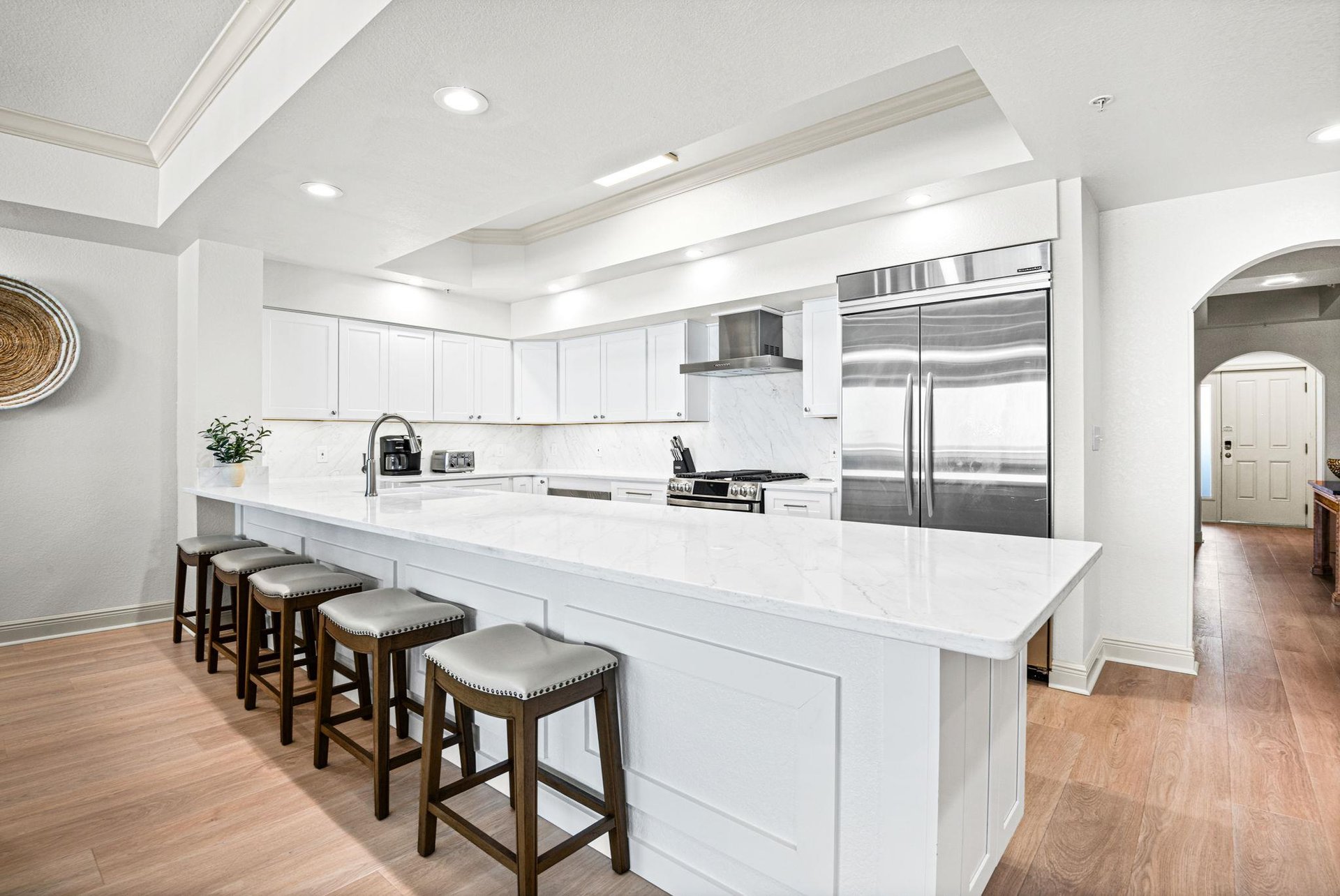 Chefs kitchen with quartz countertops, and professionalgrade stainless appliances. The spacious island with bar seating invites gatherings and conversation.