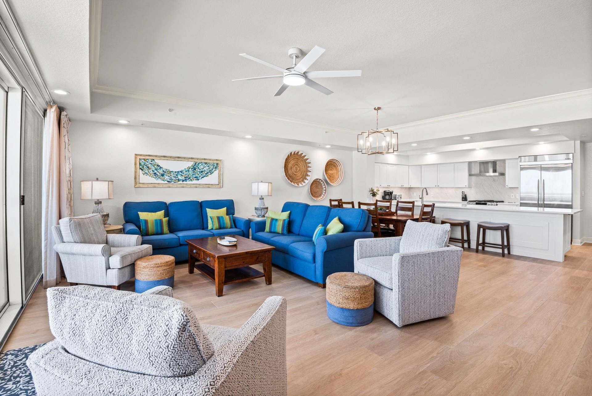 Settle into this openconcept living space, where thoughtful coastal decor and modern comforts blend seamlessly with the kitchen for easy vacation living.