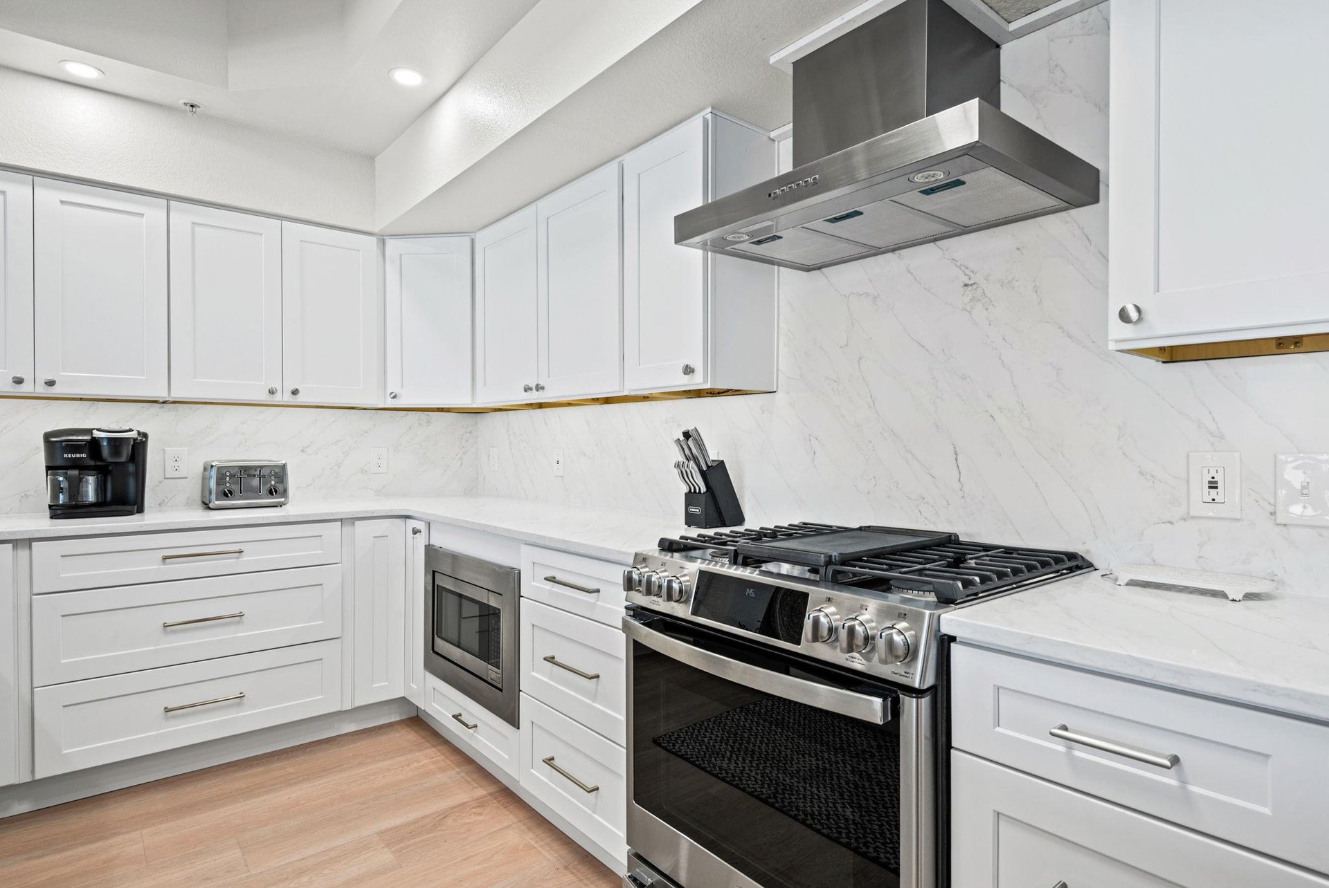 Step into the sleek, modern kitchen with stainless appliances, marblestyle backsplash, and all the tools to whip up memorable meals during your stay.