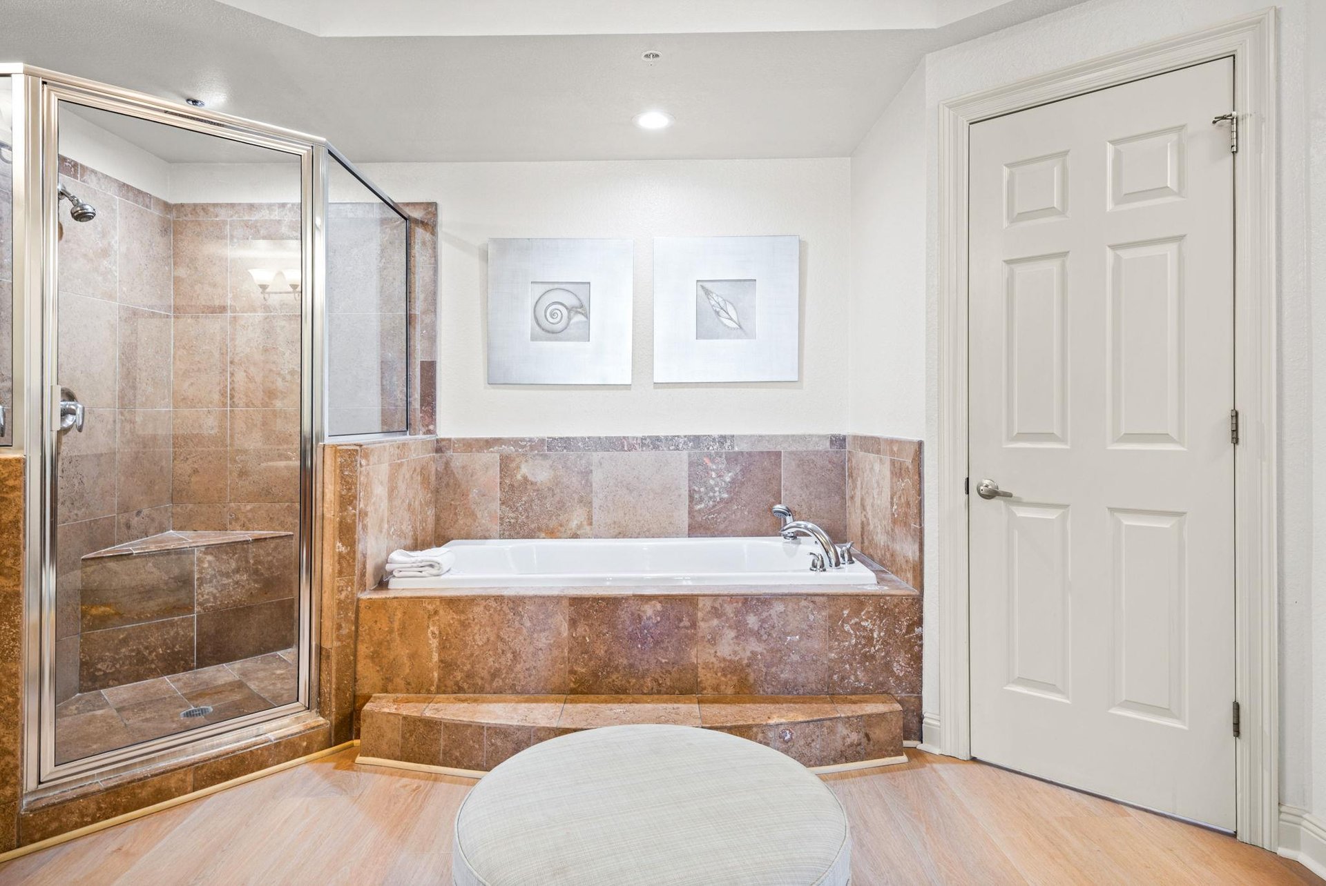Unwind in the primary bathroom, with a soaking tub and spacious tiled shower—perfect for relaxing after a full day of adventures.
