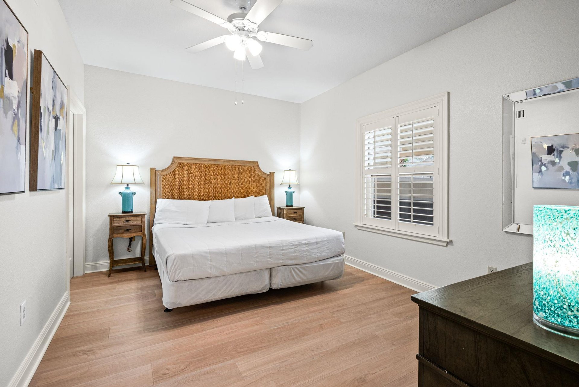 Sink into the comfort of the coastalinspired bedroom, where crisp linens and warm wood tones create a peaceful retreat.