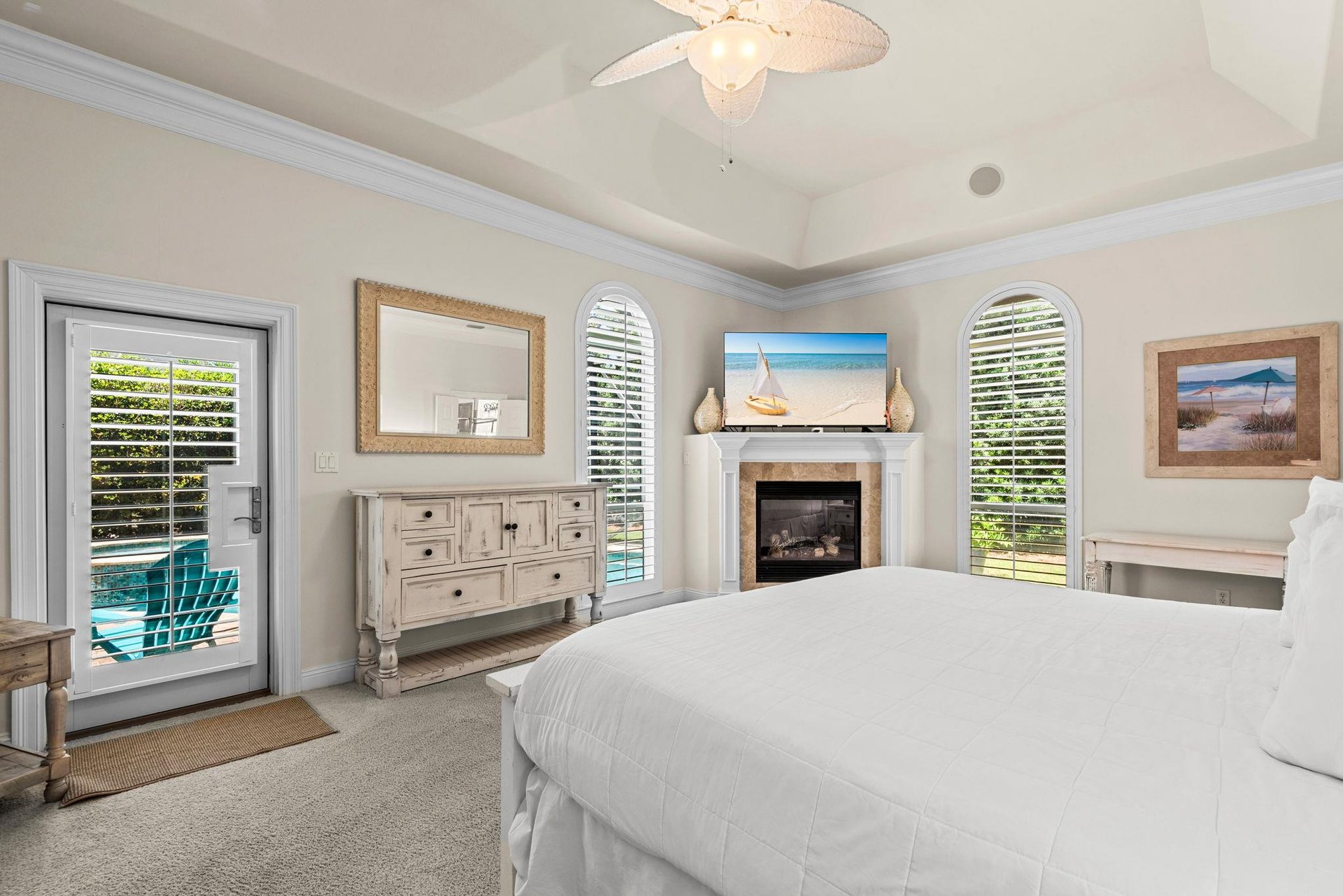 Unwind in this coastal bedroom, where direct patio access invites you to morning sunshine and peaceful poolside moments.