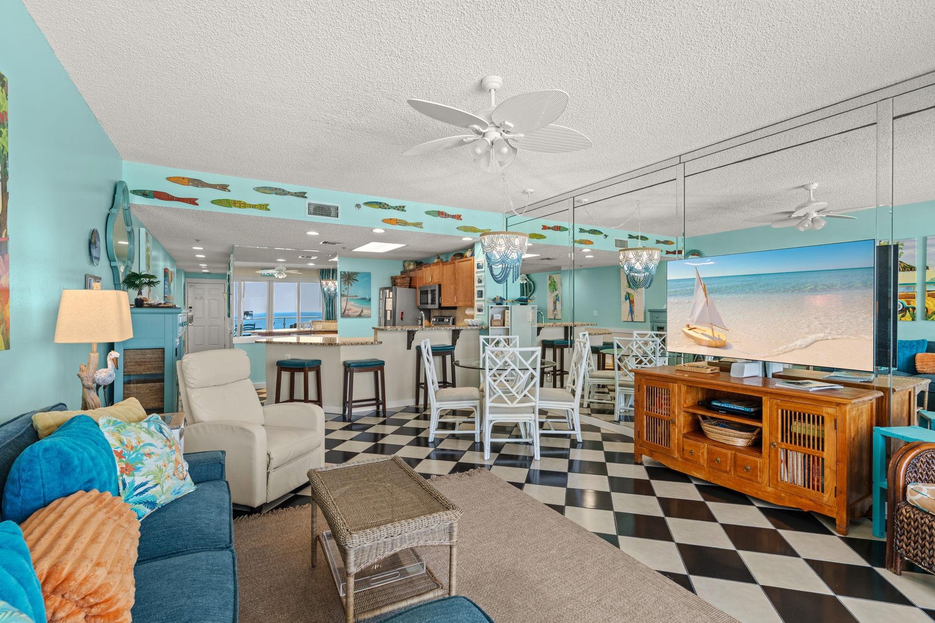 Tropical living area opens to kitchen, dining,  hallway that leads to two bedrooms  front door.