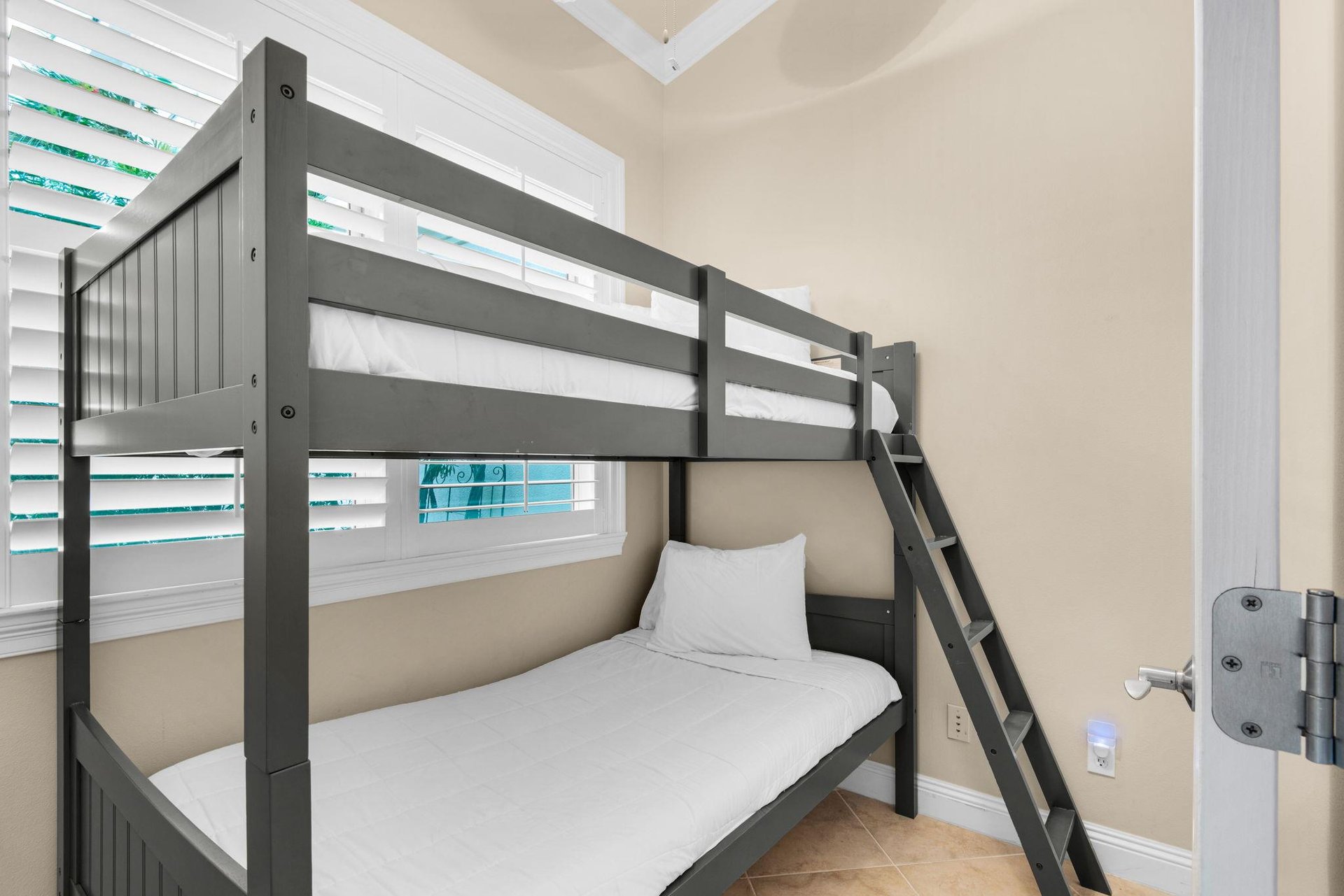 A cozy bunk room awaits nearby, while the dining and living spaces invite you to relax and gather.