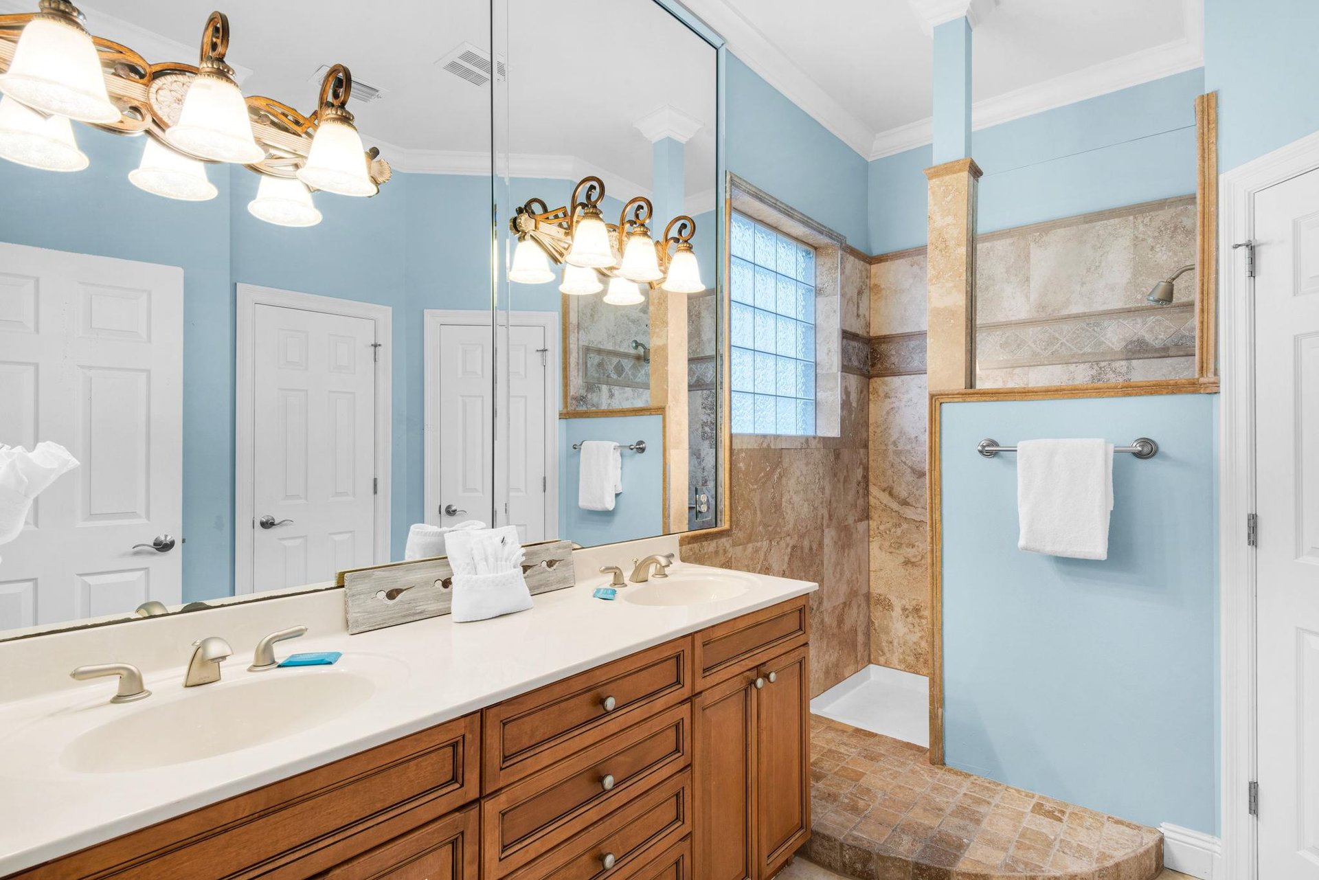 The 2nd floor bathroom features soothing aqua tones and a spacious walk in shower and double vanities.