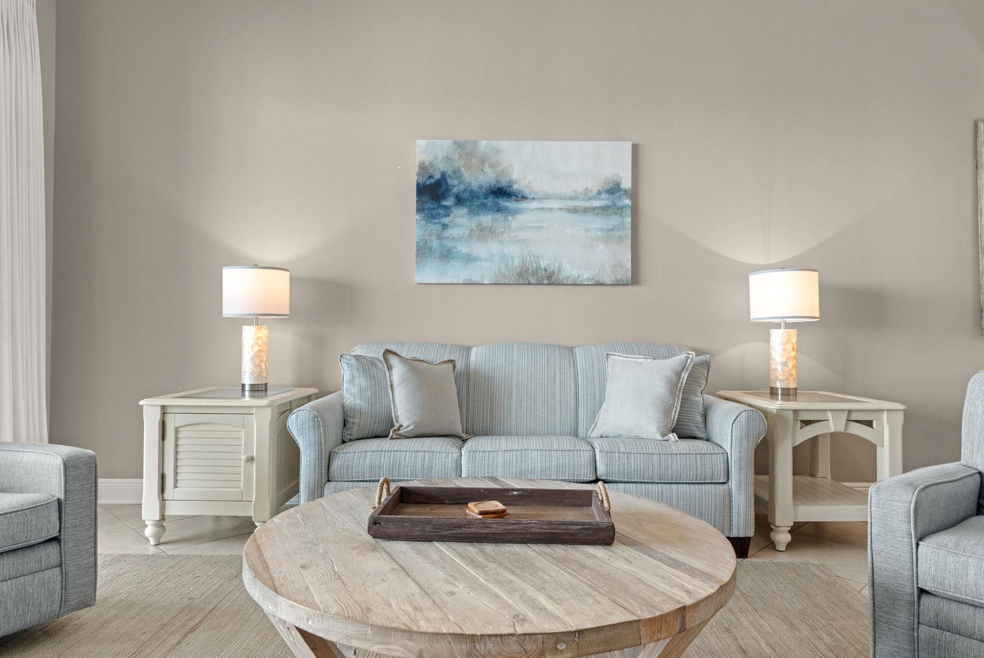 Unwind in your living room, where calming blues and soft grays create a peaceful retreat.
