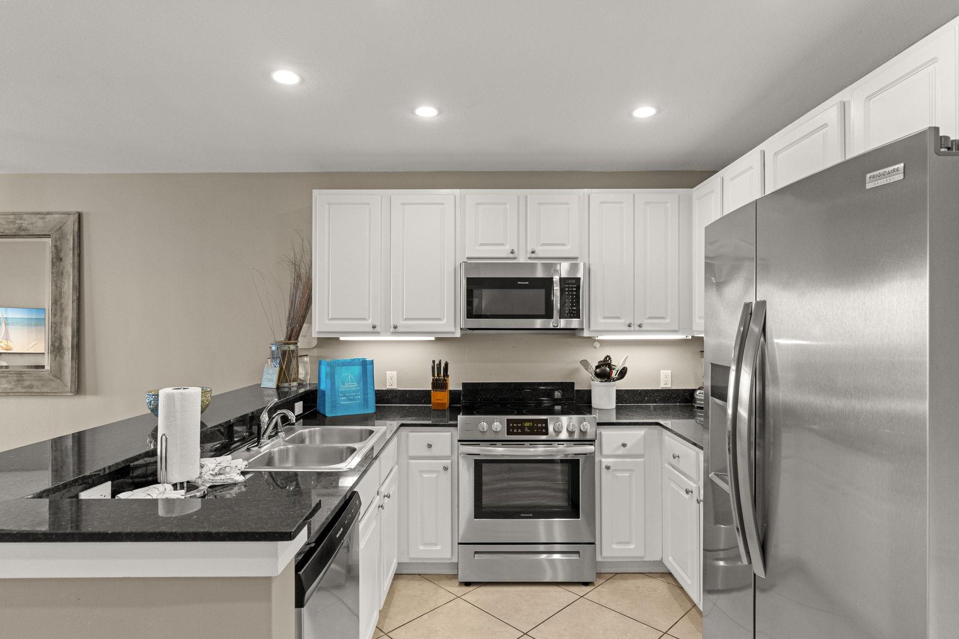 Your fully equipped kitchen features stainless steel appliances, sleek white cabinetry, and granite countertops—perfect for preparing favorite meals during your stay.