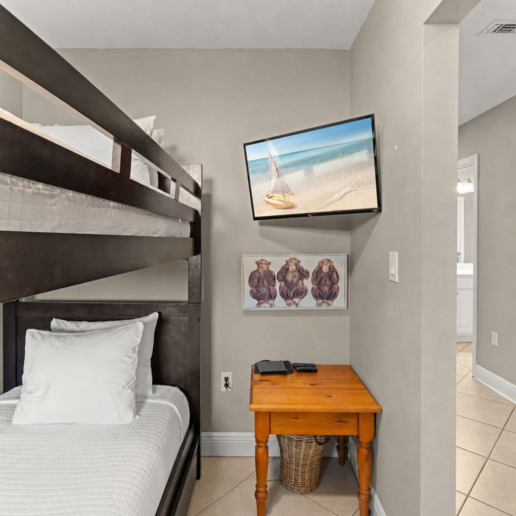 The bunk area setup offers cozy sleeping arrangements with a flatscreen TV for entertainment.