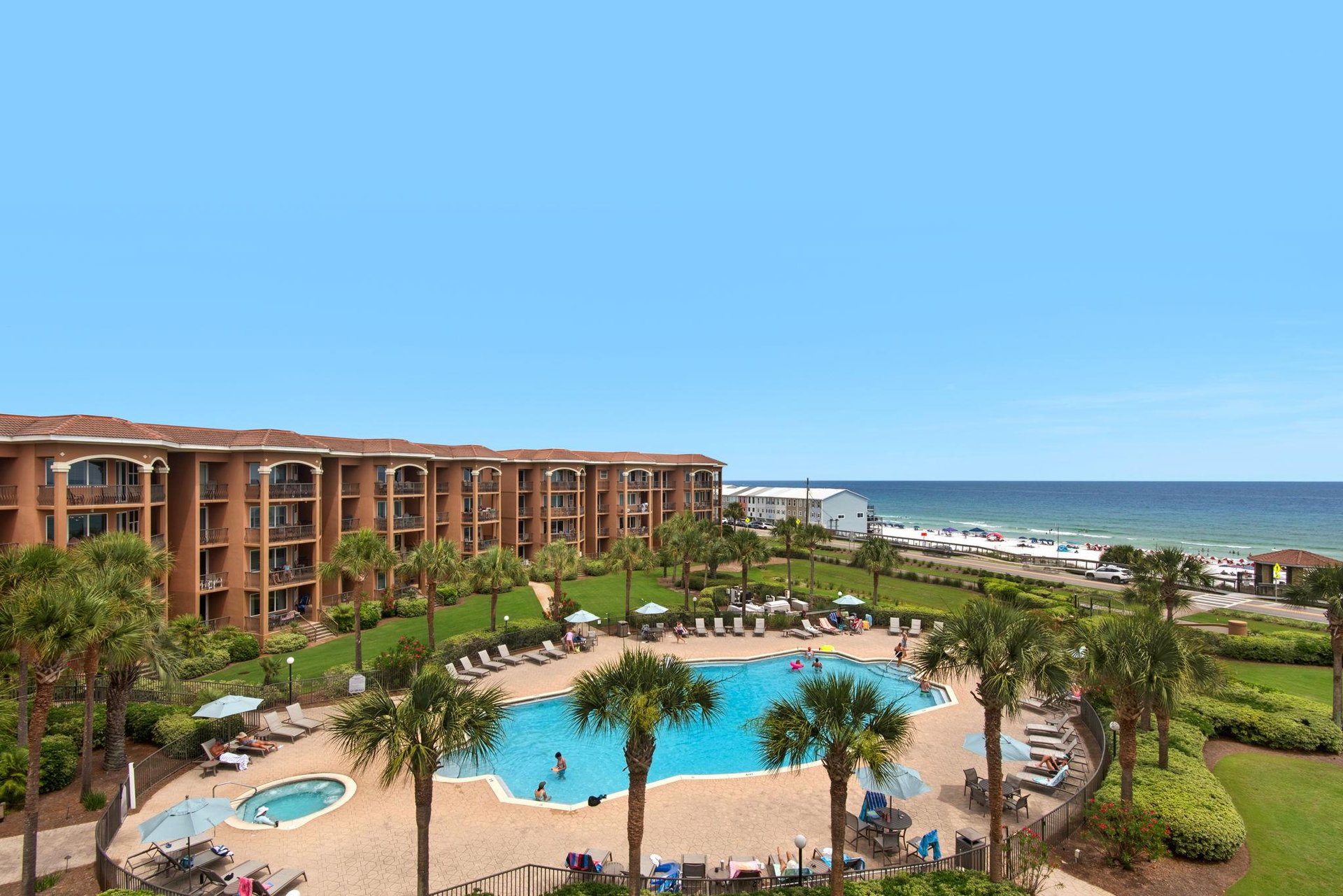 Mediterranea features an outdoor swimming pool, hot tub, and manicured grounds with palm trees.