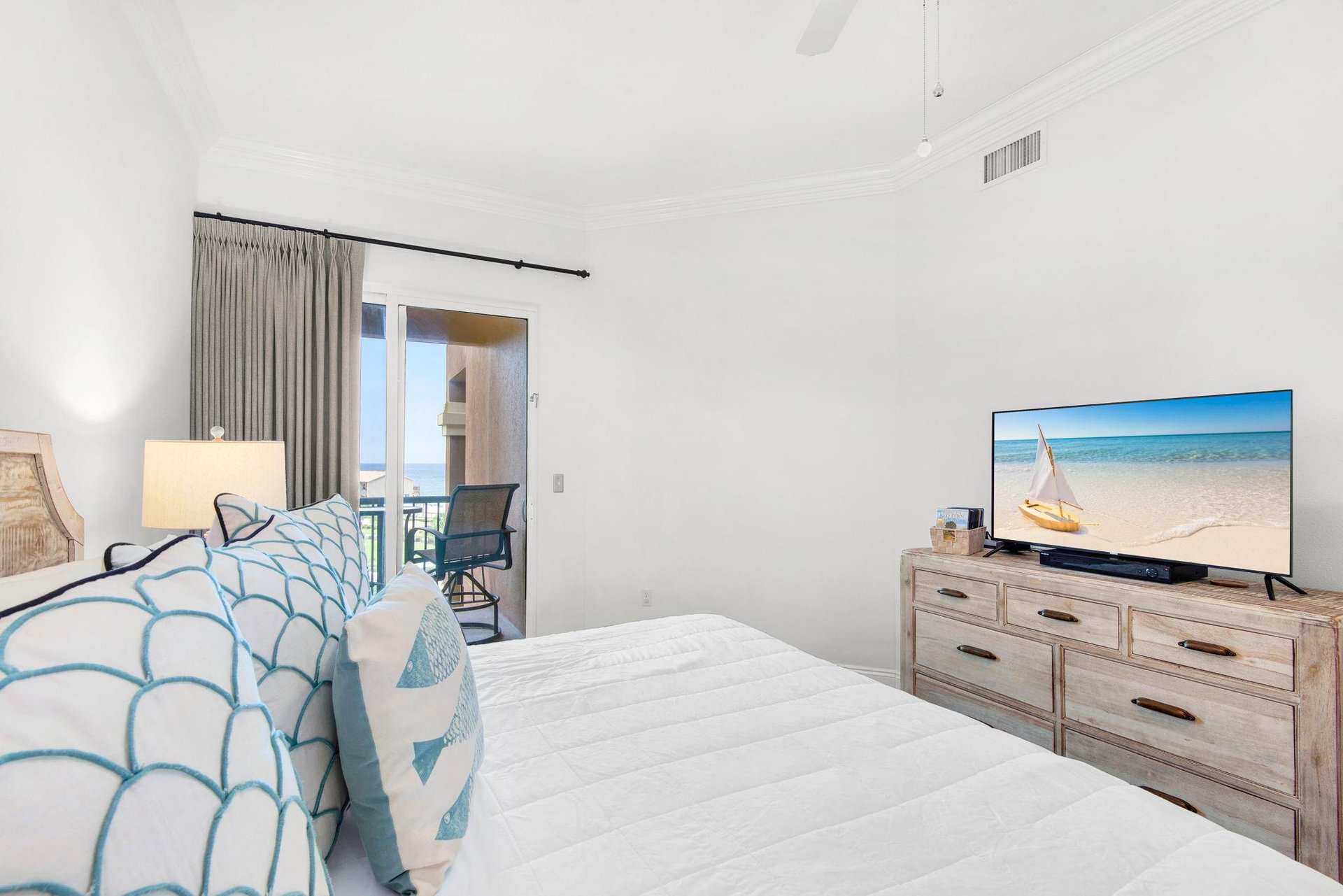 Sink into the Primary bedroom where soothing beach tones invite total relaxation.