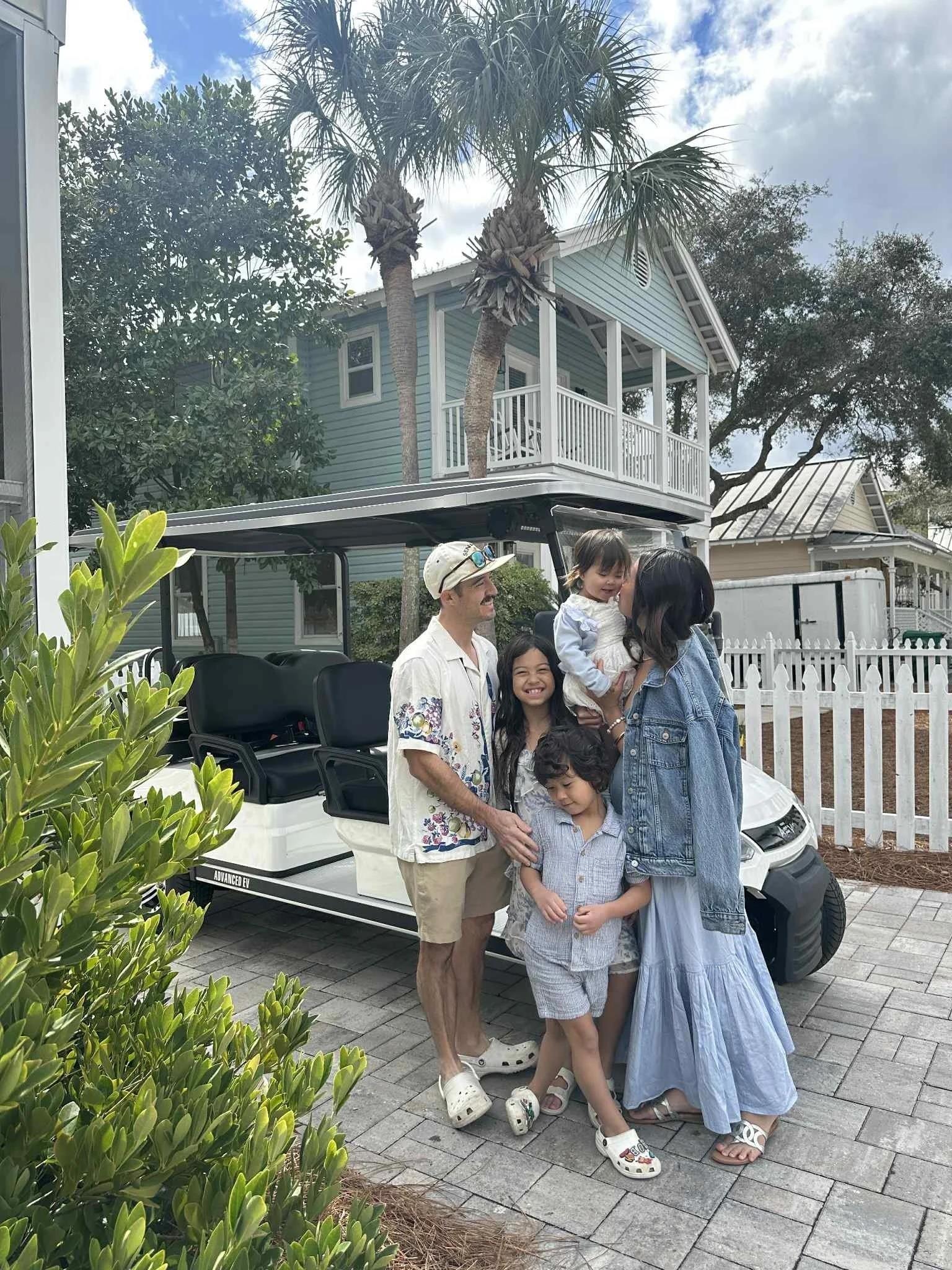 a group of people standing outside a house