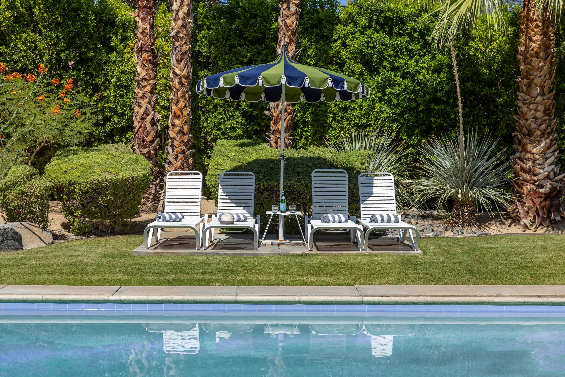 Four white pool loungers