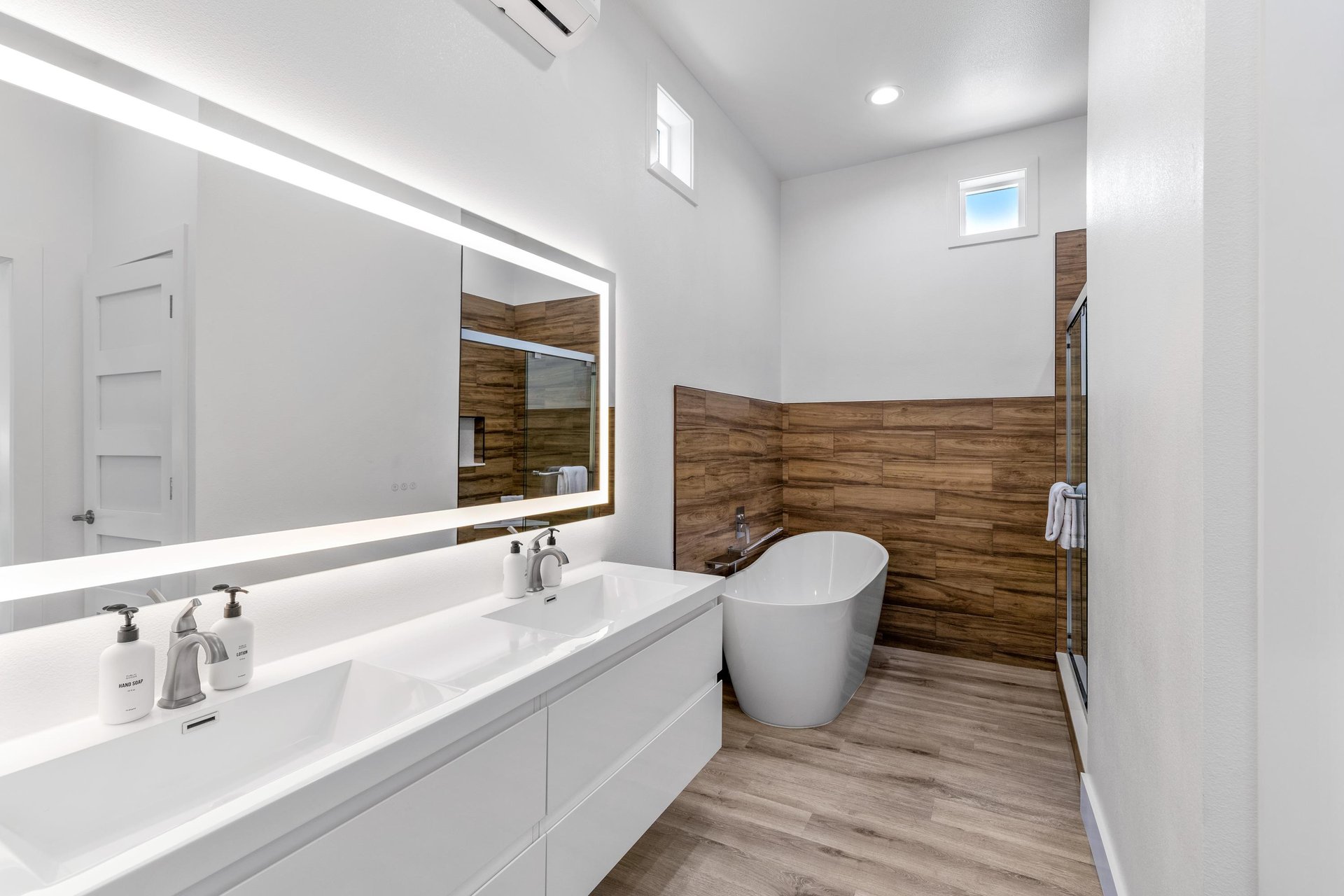 Primary bedroom en suite with dual vanity sinks