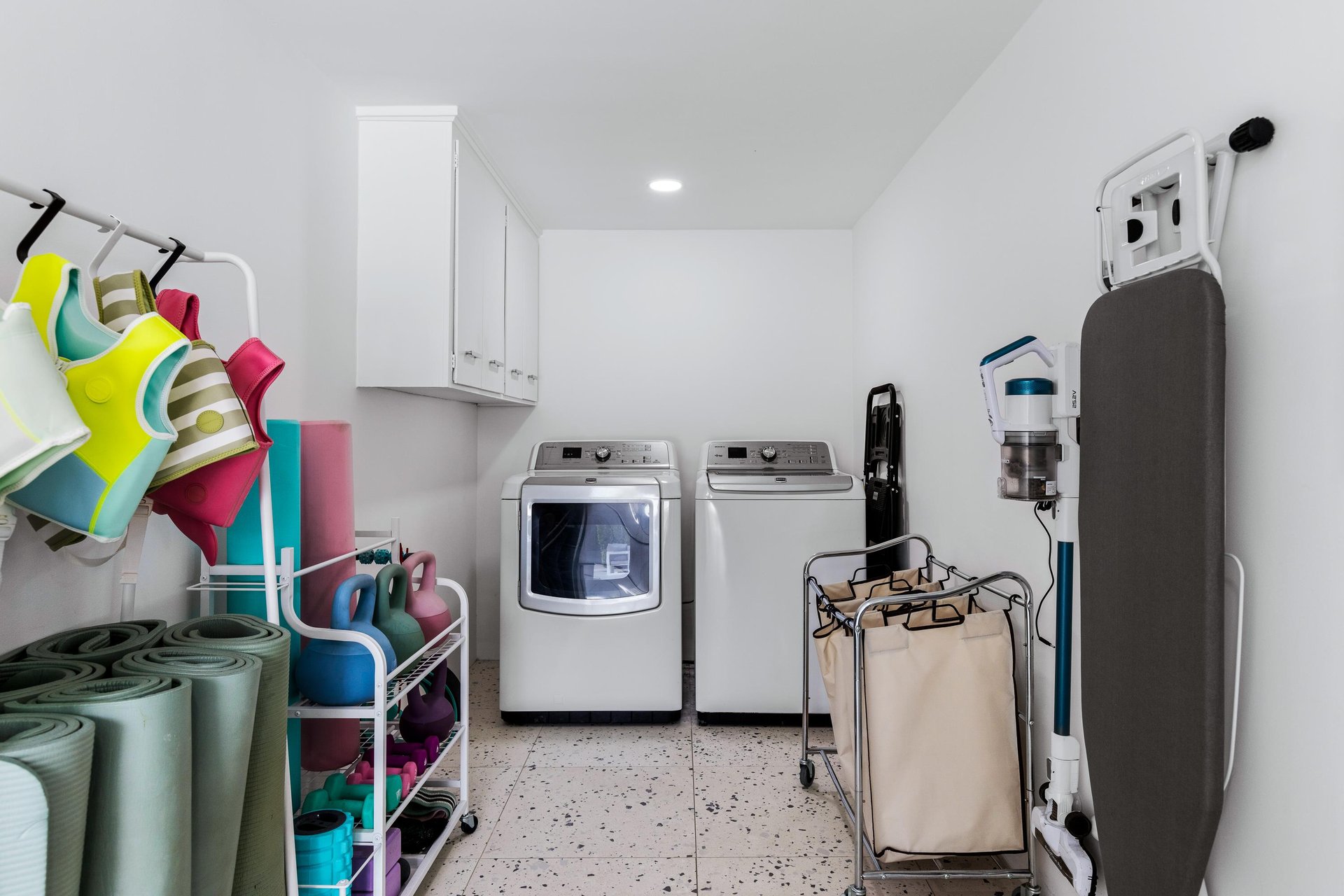 Extrasized laundry room with exercise equipment