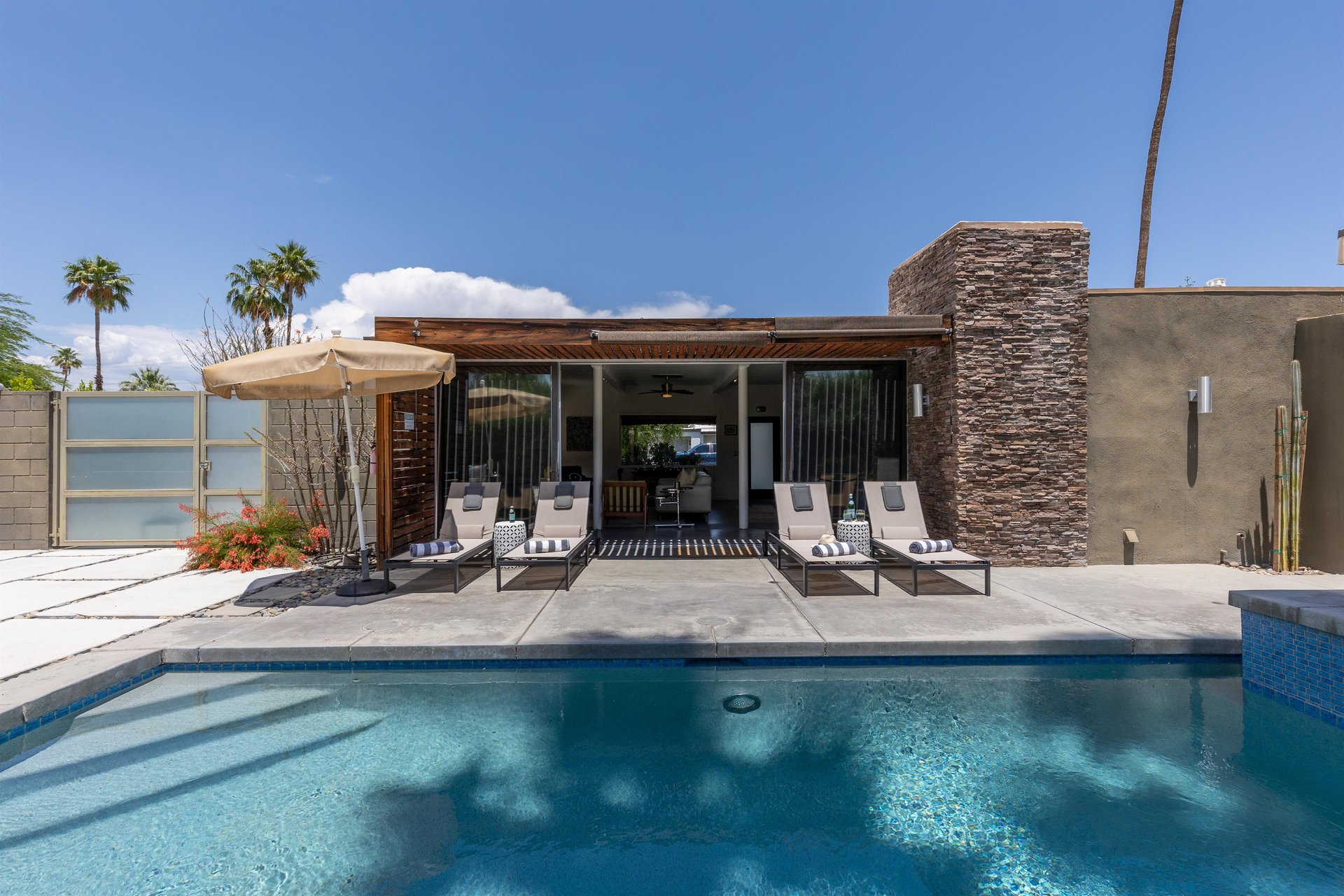 Loungers in front of glistening pool