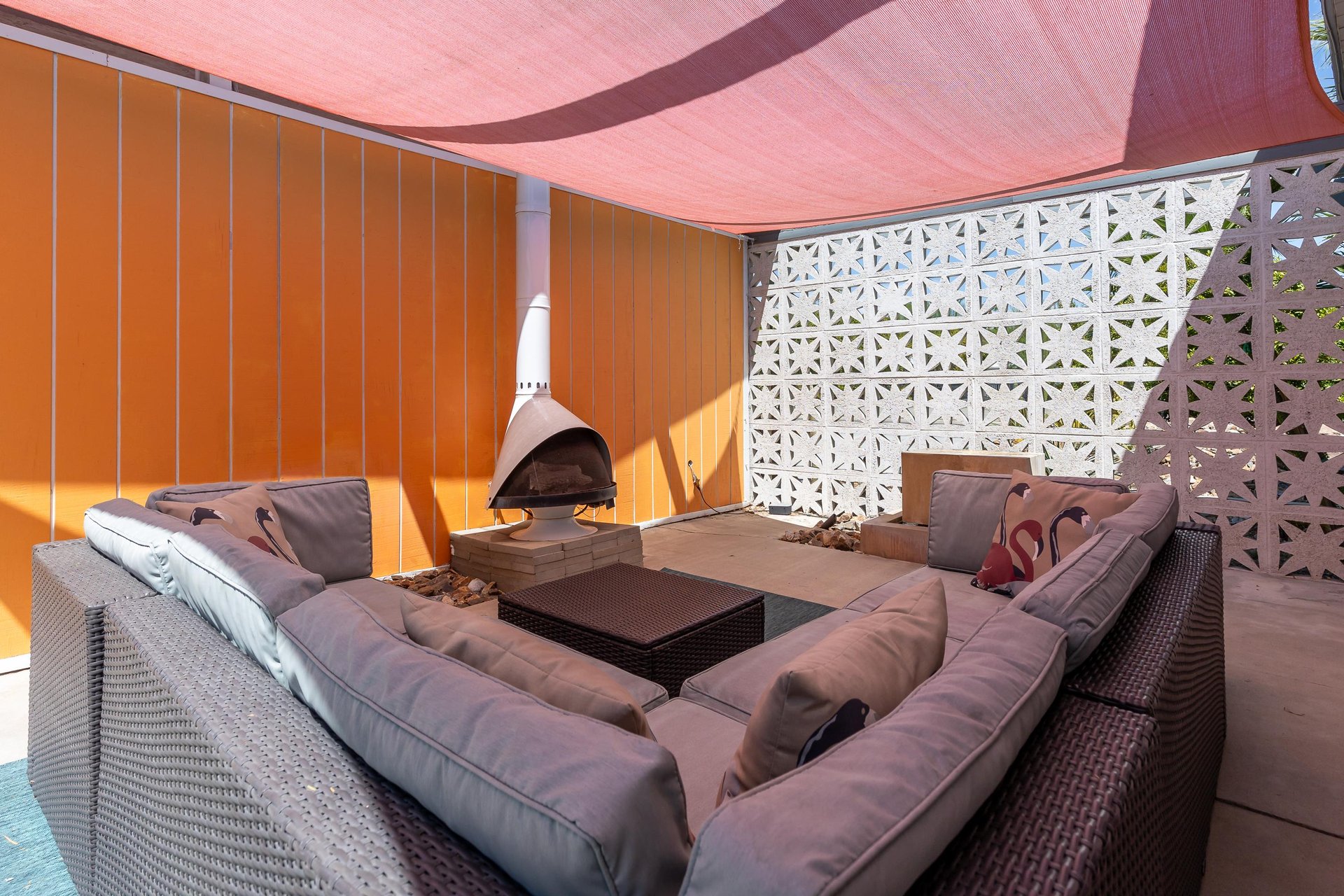 Covered outdoor lounge area with fireplace