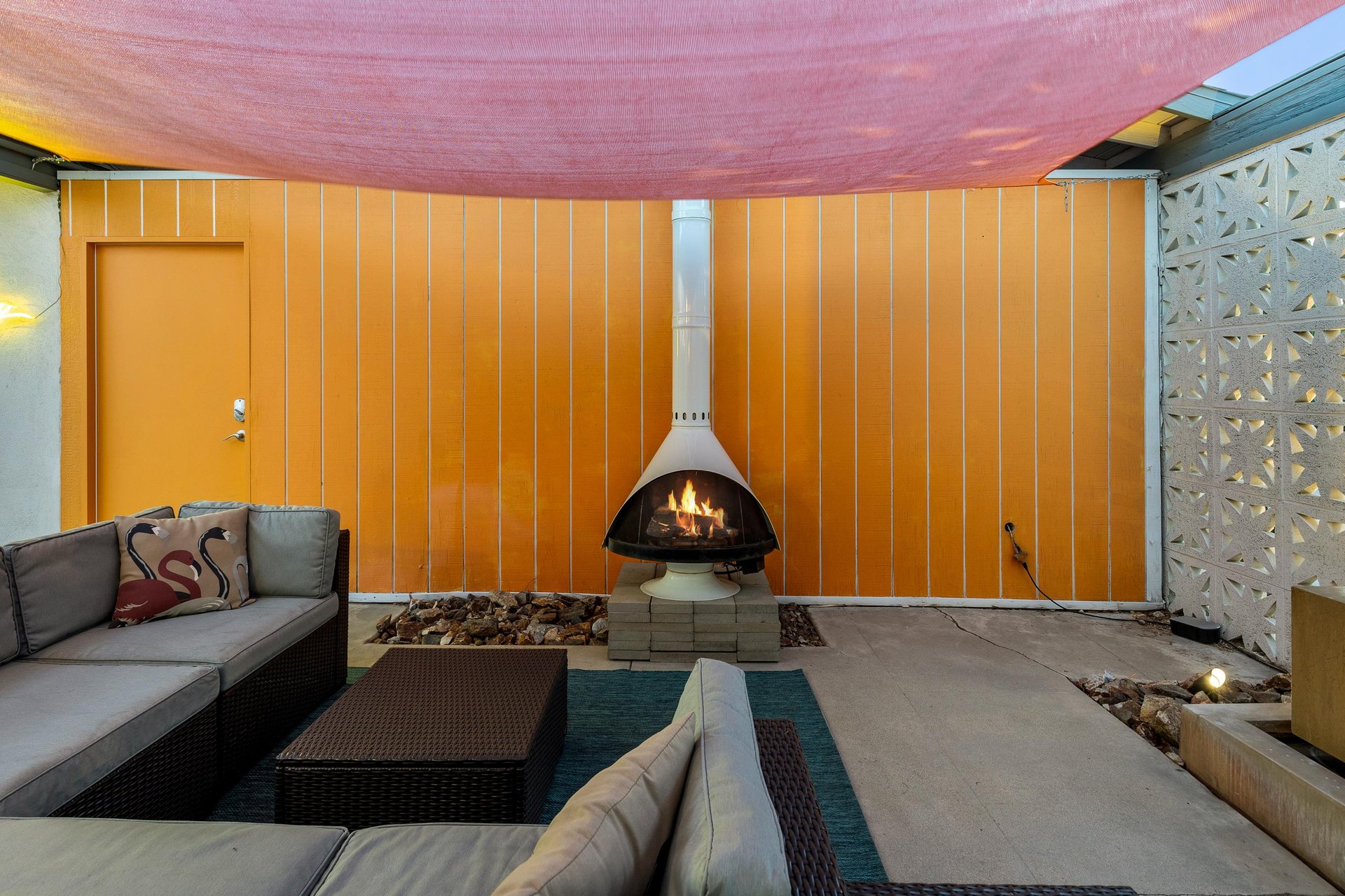 Covered outdoor lounge area with fireplace