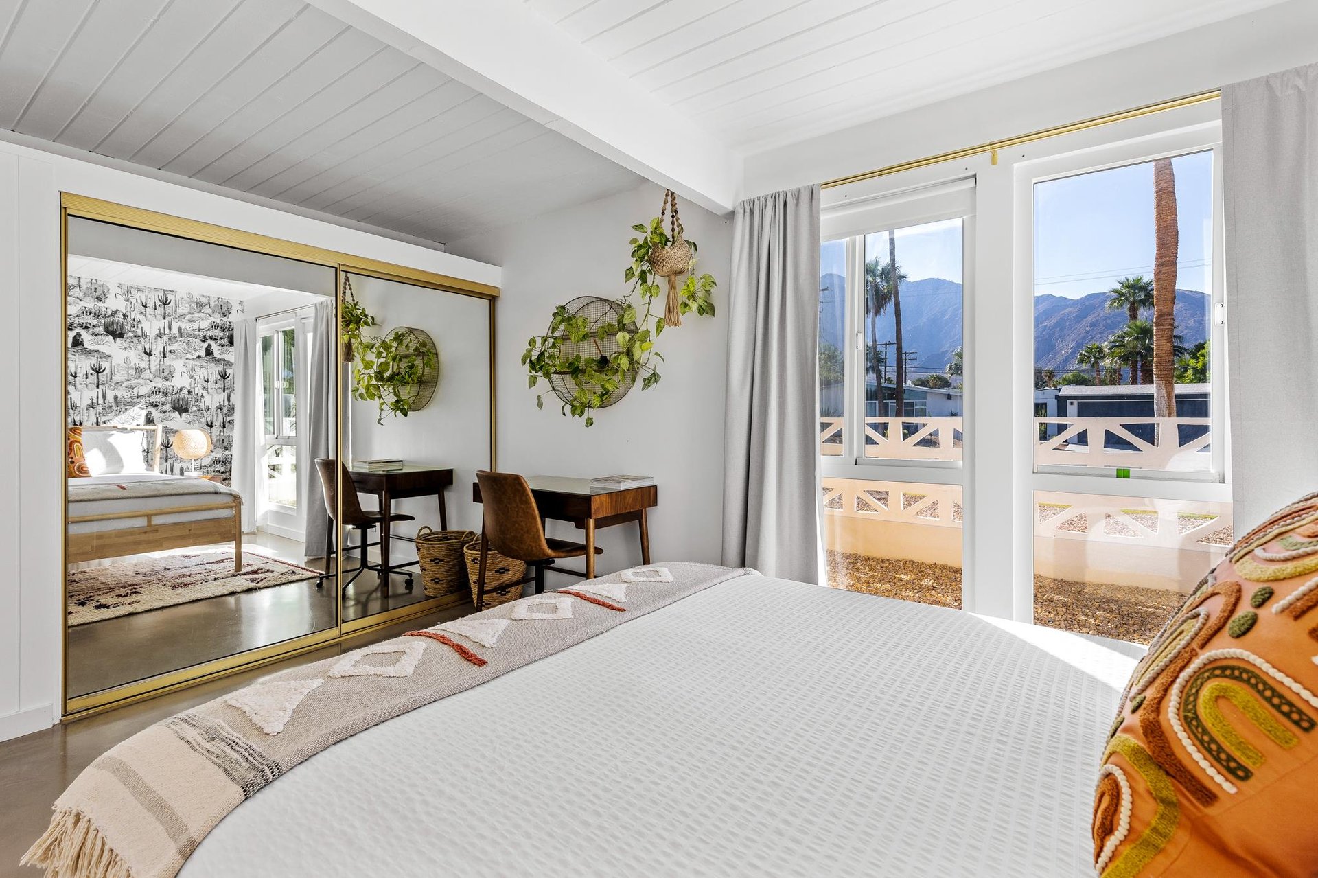 Guest bedroom with huge picture windows and a desk