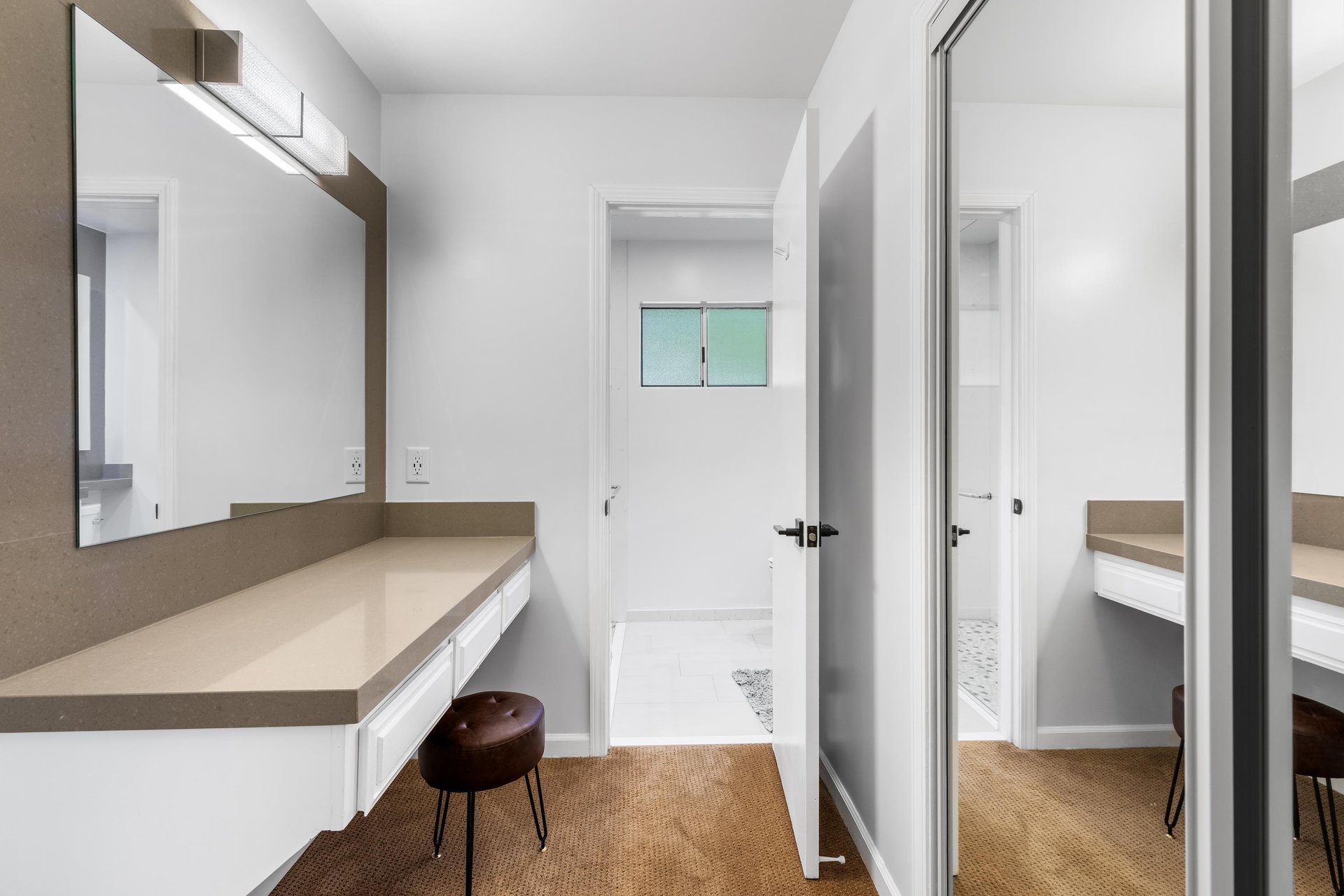 Primary en suite bathroom with make up station