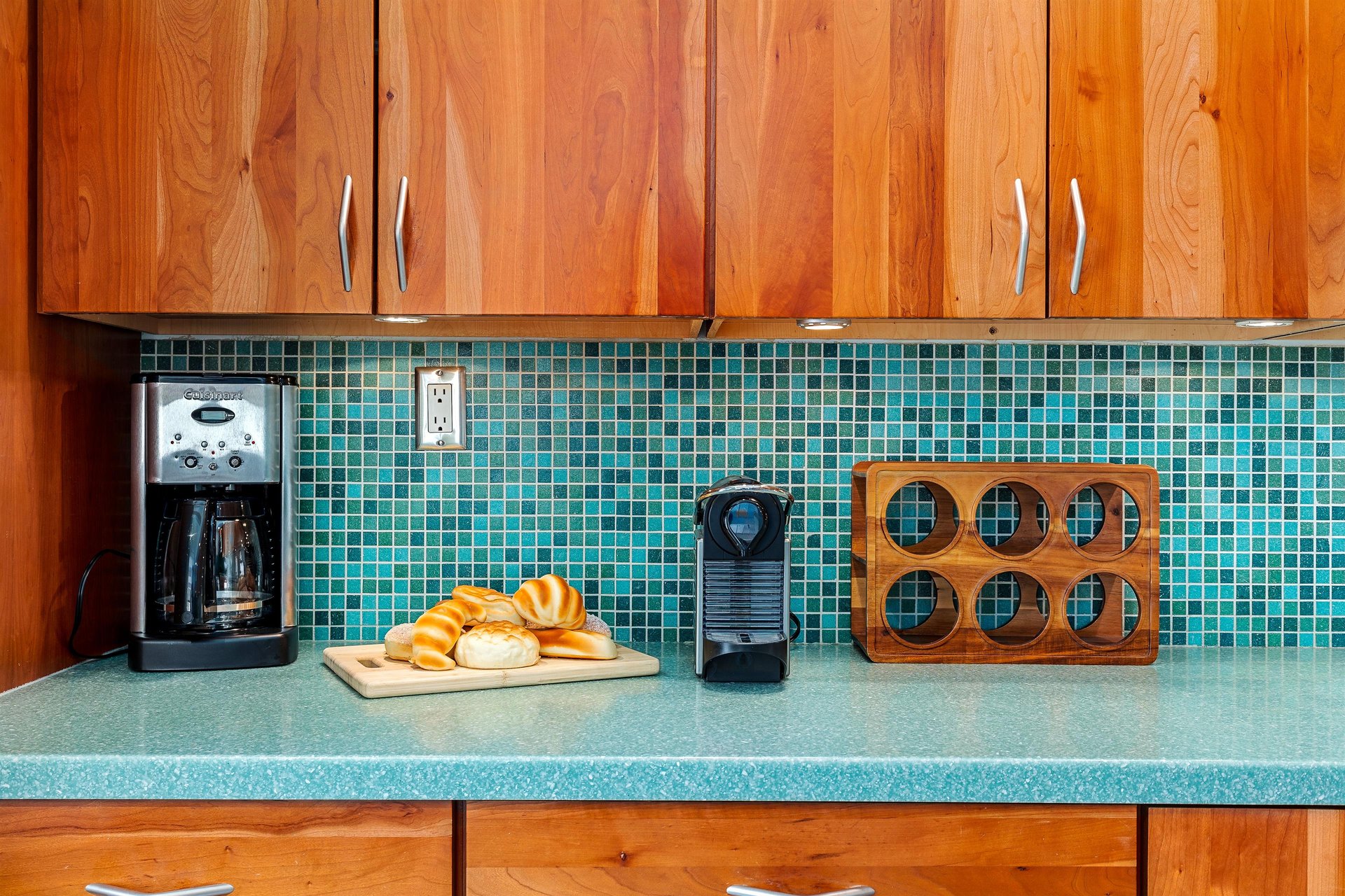 Captivating blue backsplash and timeless wood cabinets