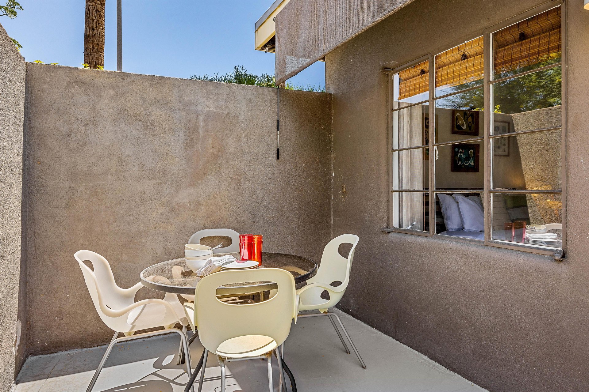 Private patio with outdoor dining set for four