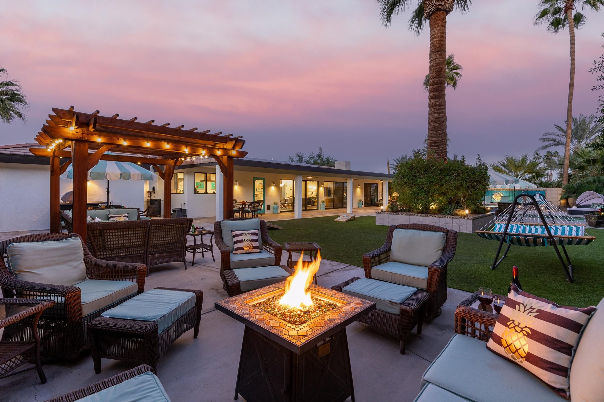 Curl up around the fire as the sun sets in the palm tree studded sky