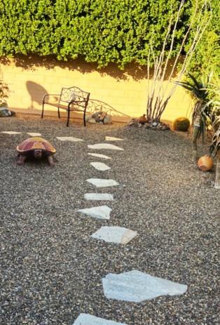 Your private garden oasis awaits with charming stone pathways winding through thoughtfully designed landscaping.