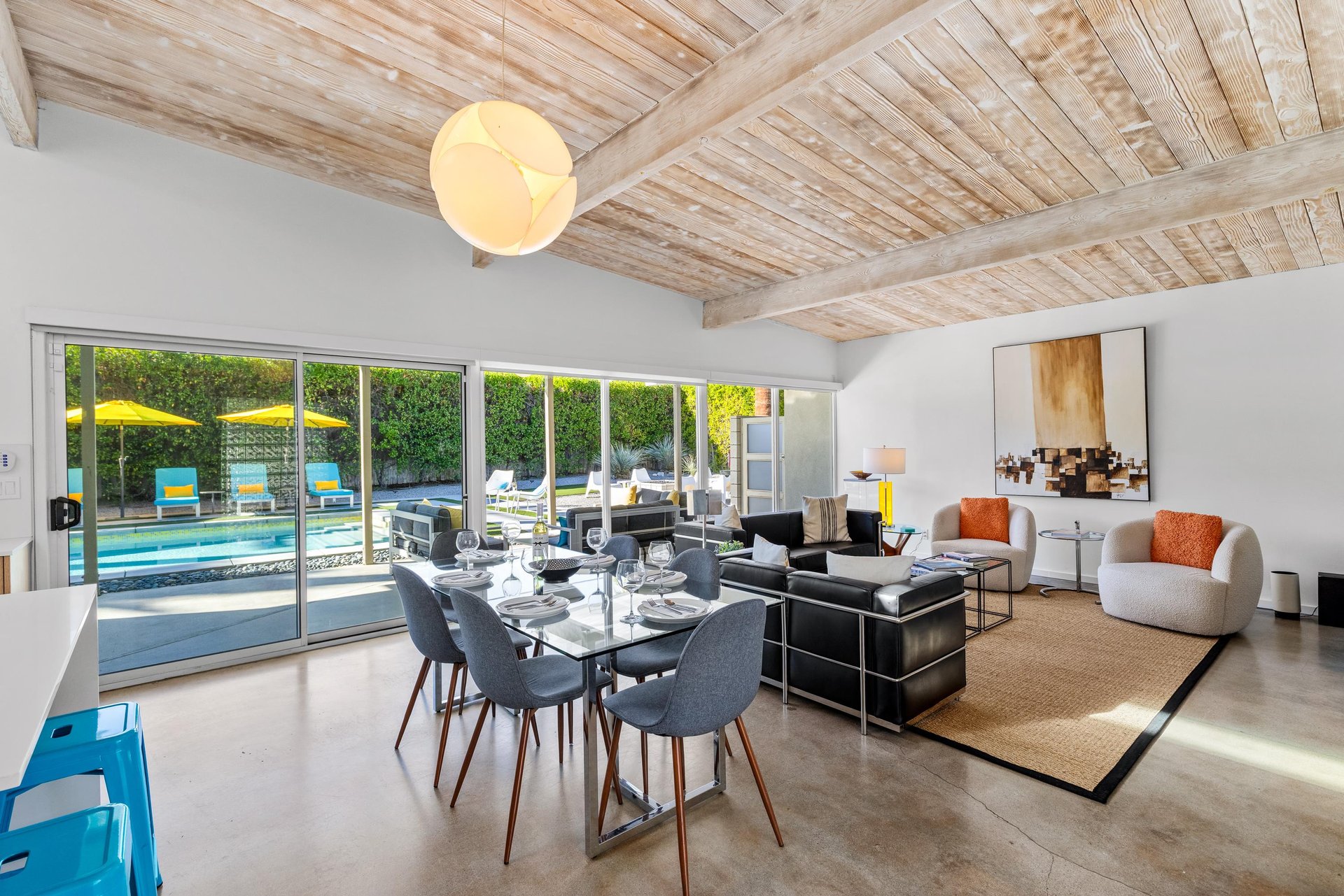 Relax in this stunning openplan space where natural wood beams meet modern comfort, with pool views just steps away.