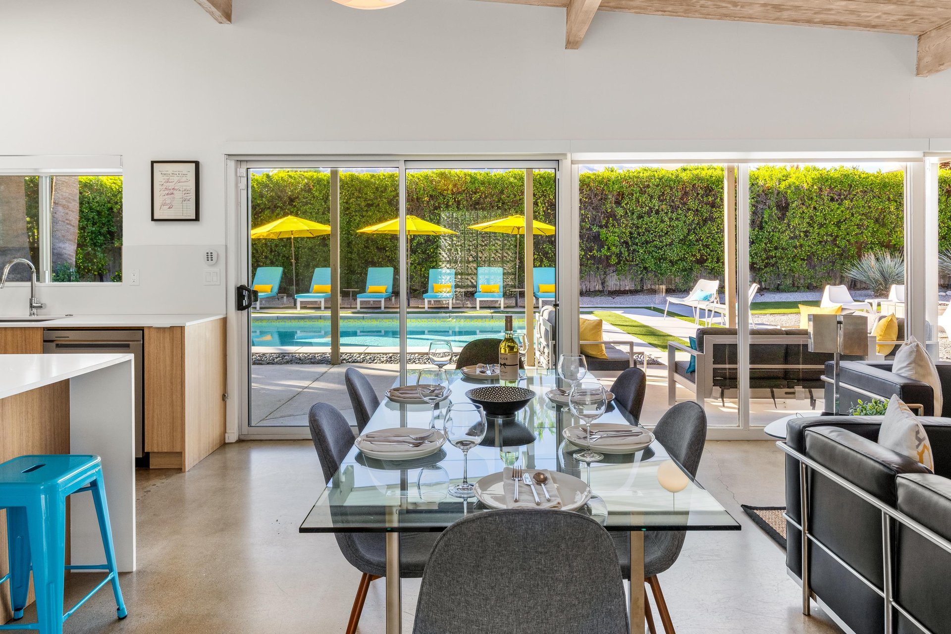 Your open dining space flows seamlessly to the sparkling pool through floortoceiling glass doors, creating perfect indooroutdoor living.