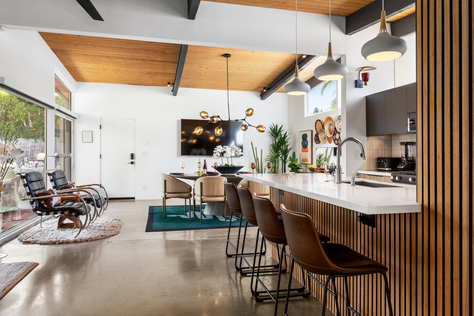 Gather around this stunning kitchen island where sleek design meets warm wood accents, creating your perfect space for morning coffee and evening conversations.