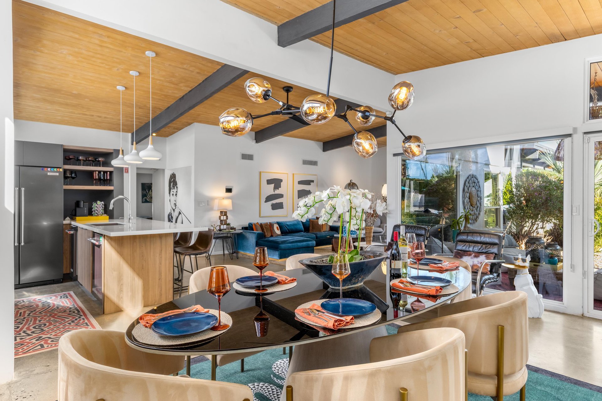 Stunning openconcept space where your dining flows into the living area, featuring warm wood ceilings and modern lighting that creates perfect ambiance.