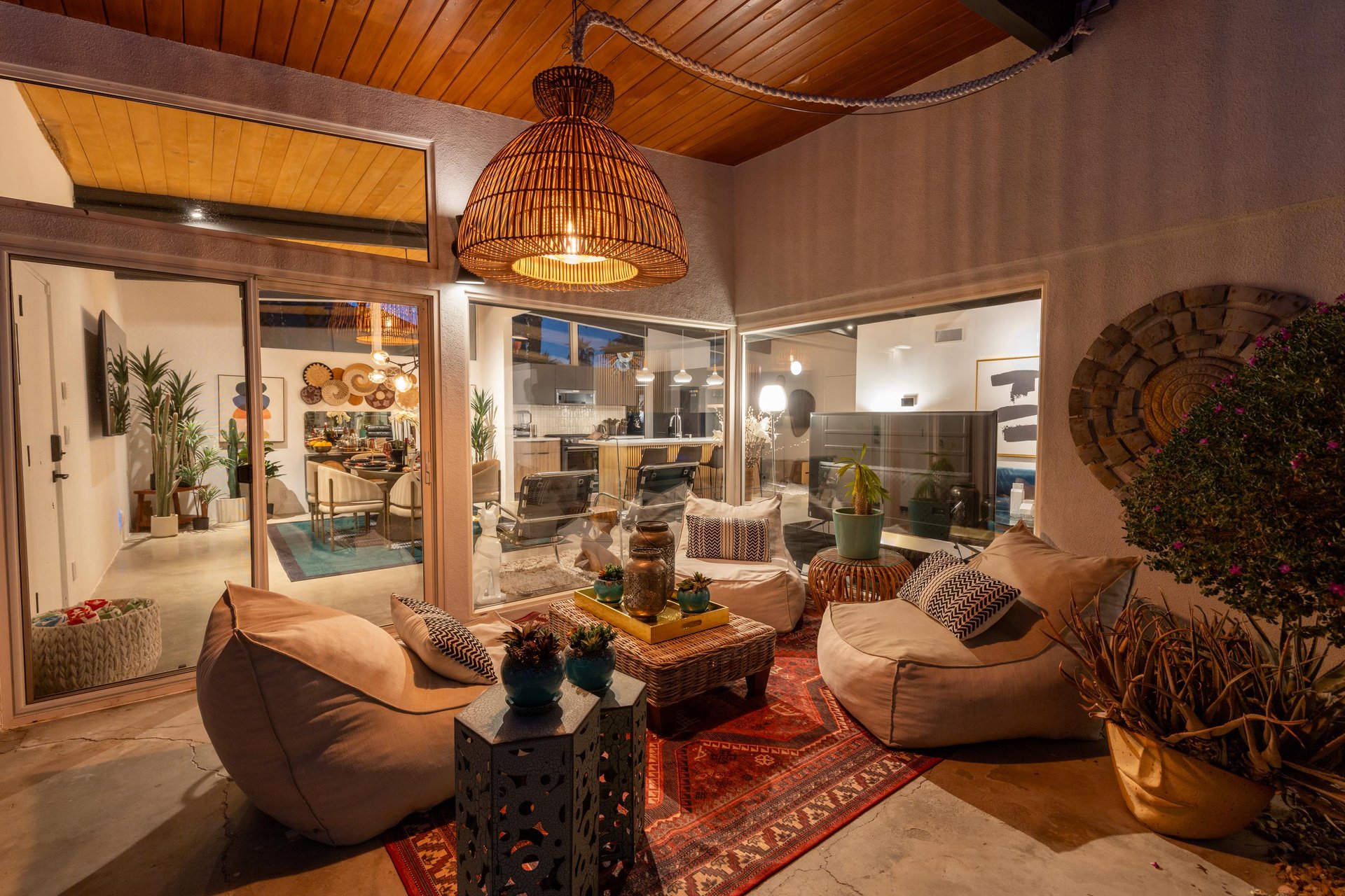 Sink into plush seating under warm pendant lighting as you gaze through floortoceiling windows into your sleek modern kitchen.