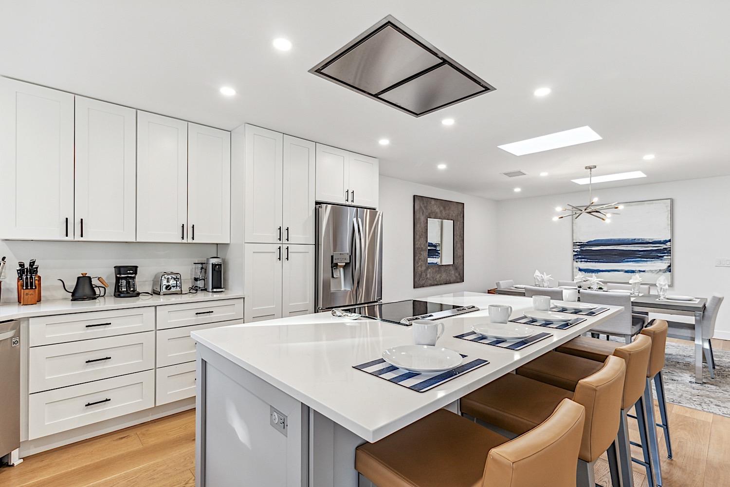 Beautiful kitchen island w induction cooktop and modern vent hood.