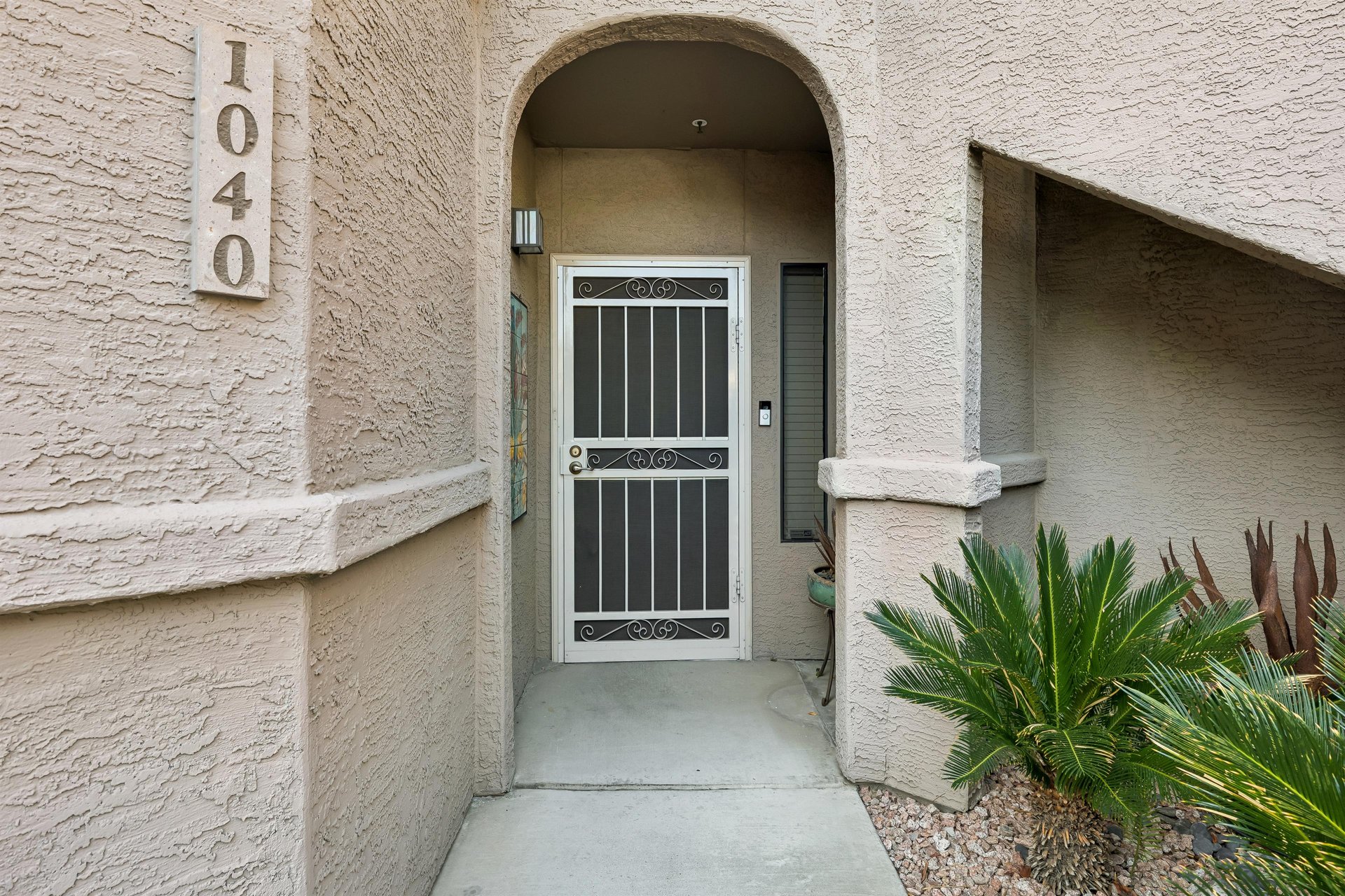 Condo entrance with secure screen door.