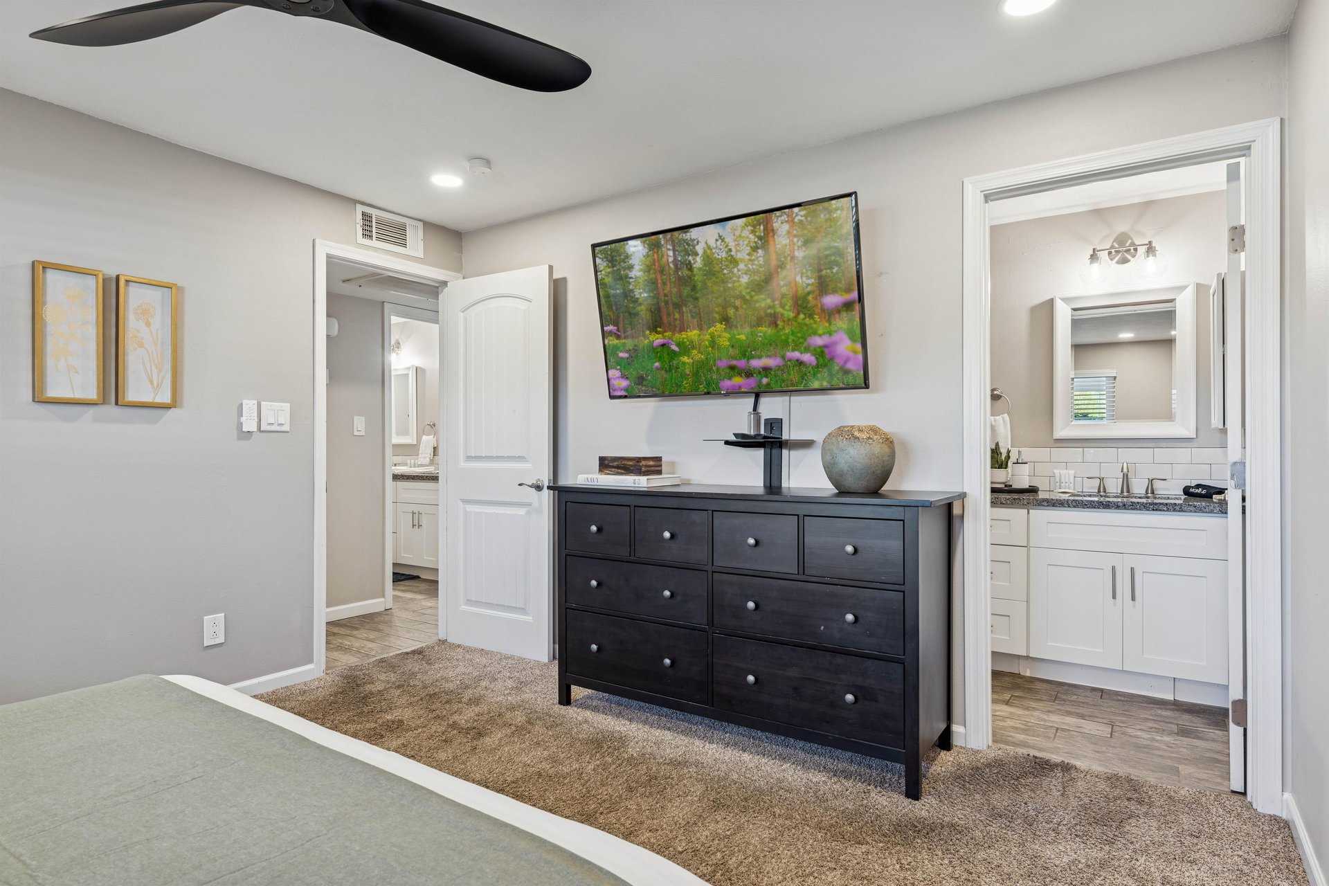 Primary bedroom with large size smart tv.