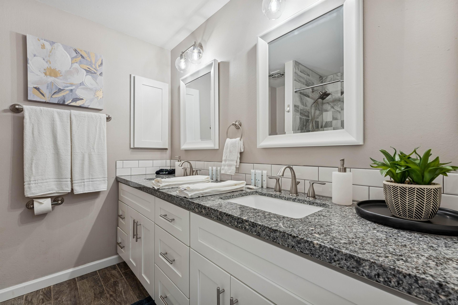 Hallway guest bathroom with dual sinks.