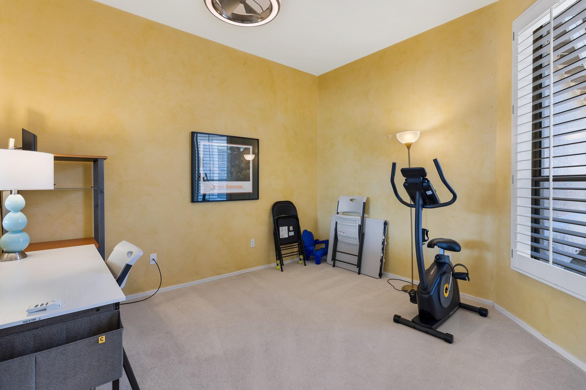 Den with exercise bike and window overlooking the formal livingdining and mountain views
