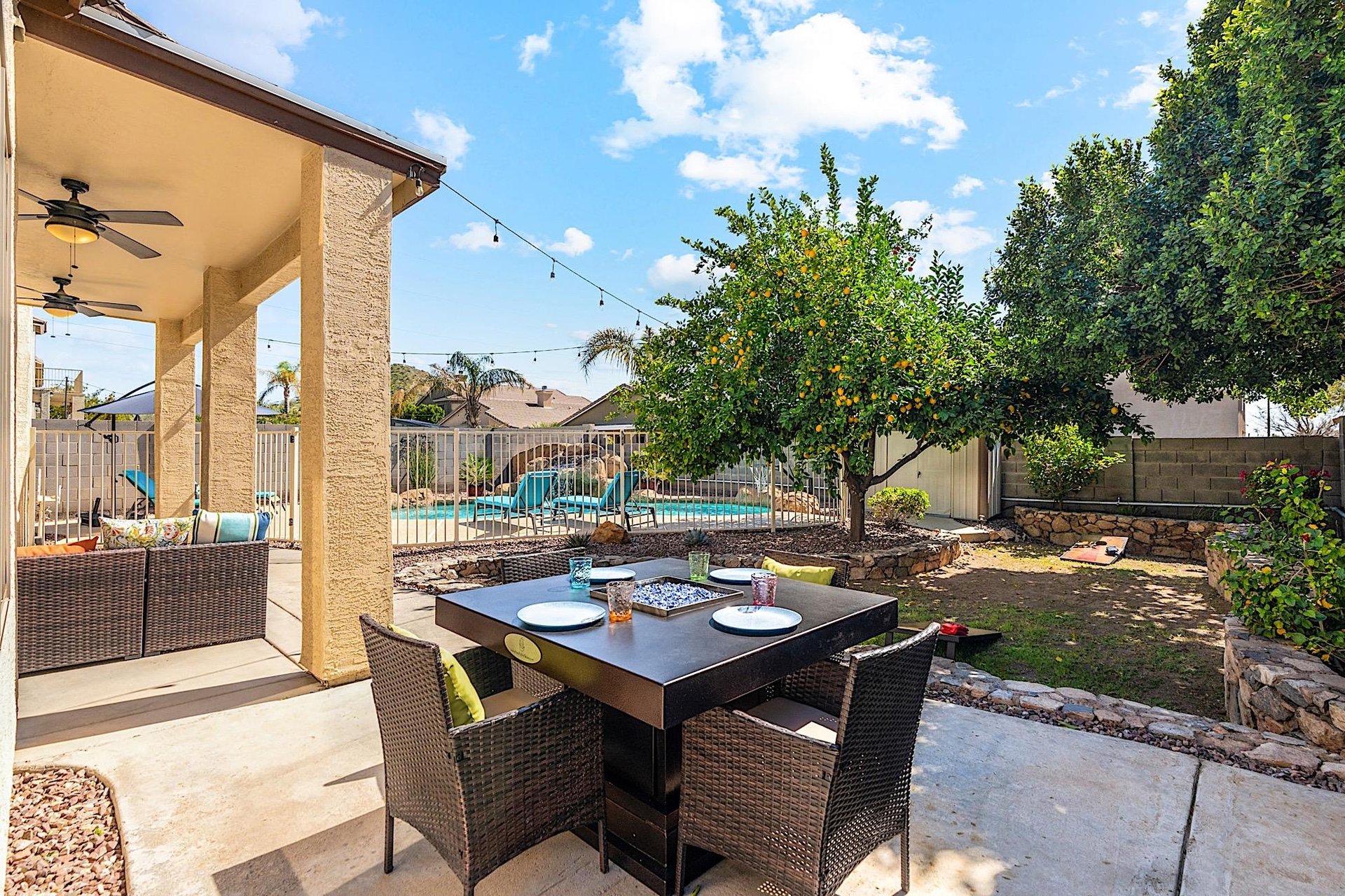 Fire pit dining table, view of citrus tree and pool
