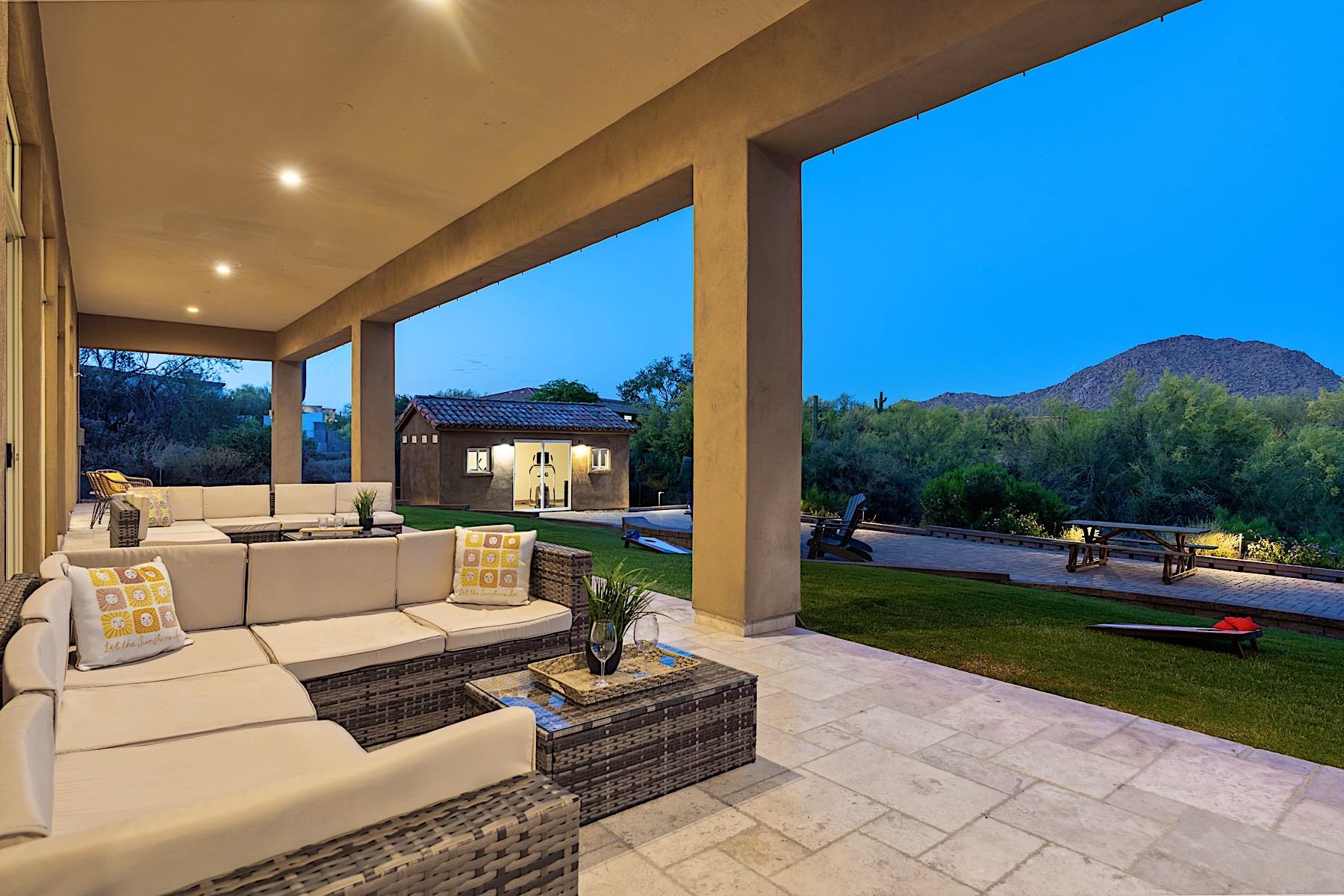 Large covered patio w 2 sectional sofas  a mounted TV