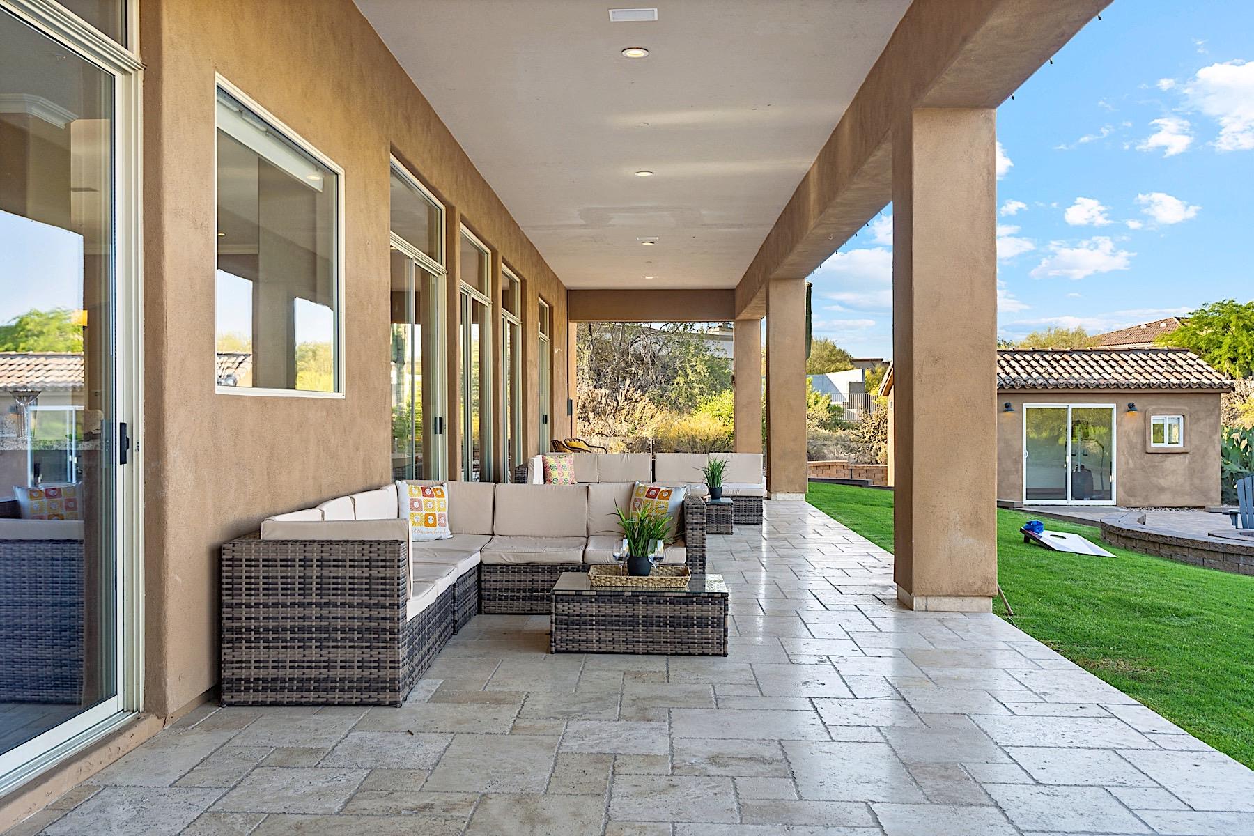 Covered patio during the day. 2 Sofas and a mounted TV