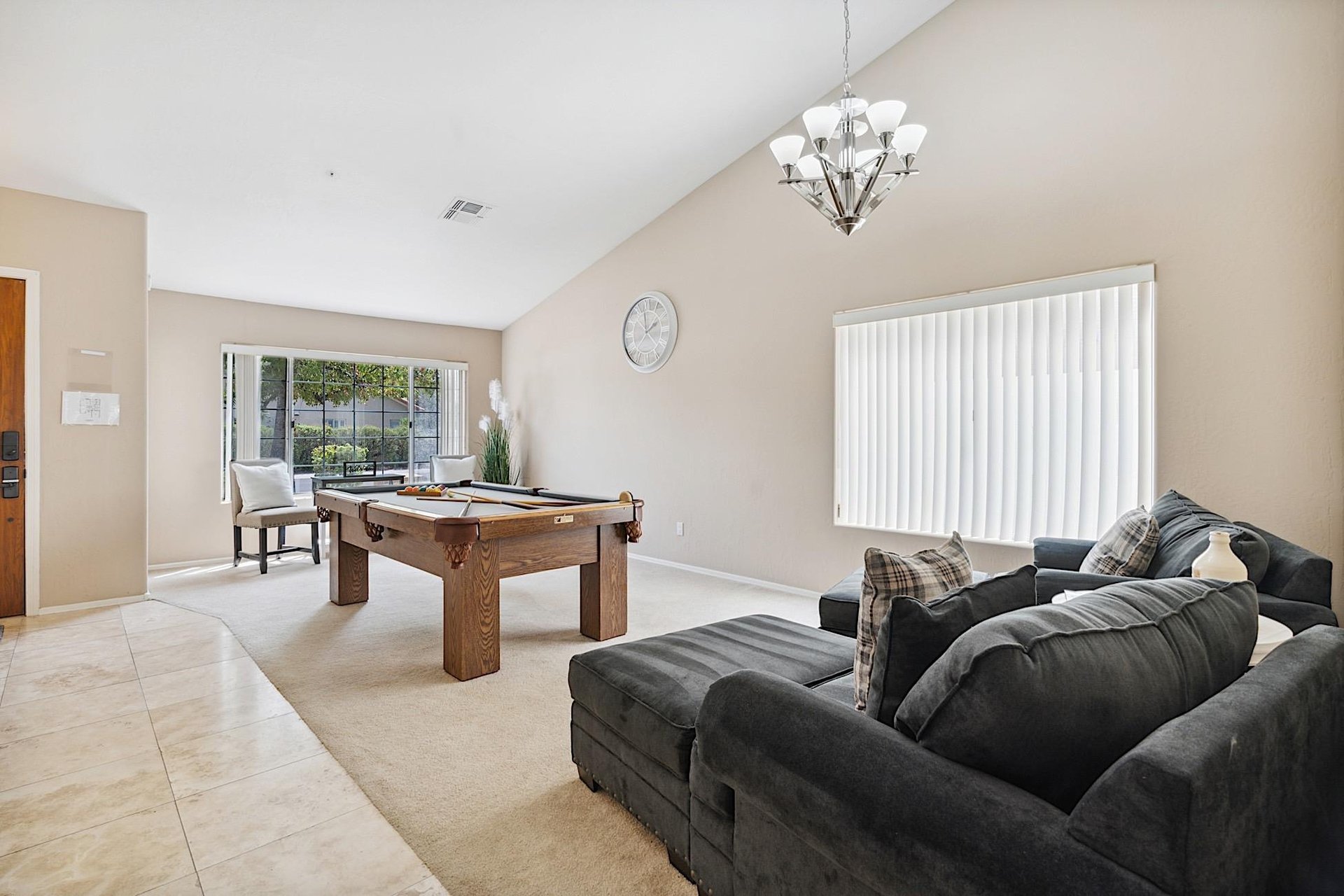 Family room has a billiard table and two oversized chairs