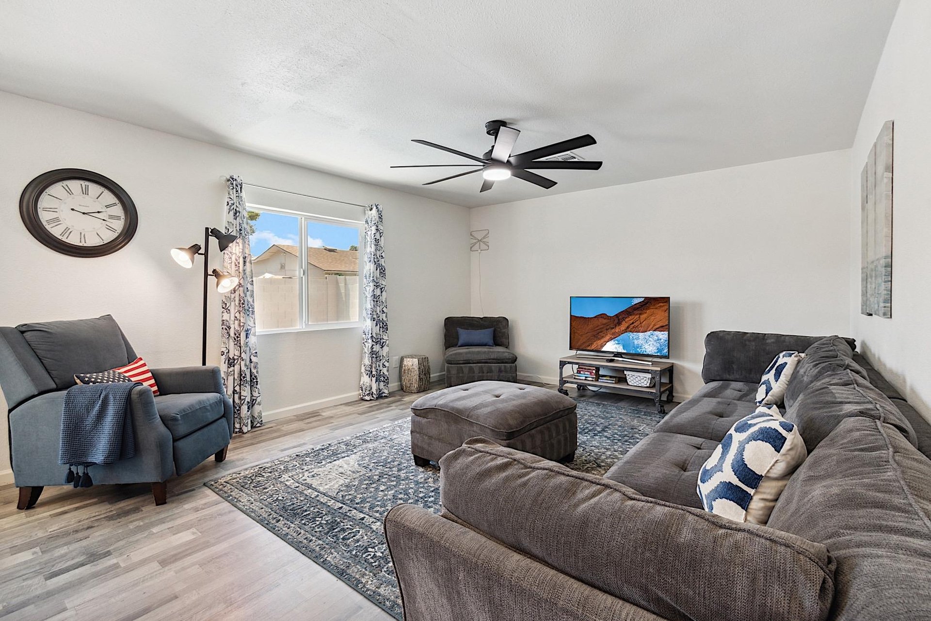 Living room has large sectional sofa, ottoman and reclining chair