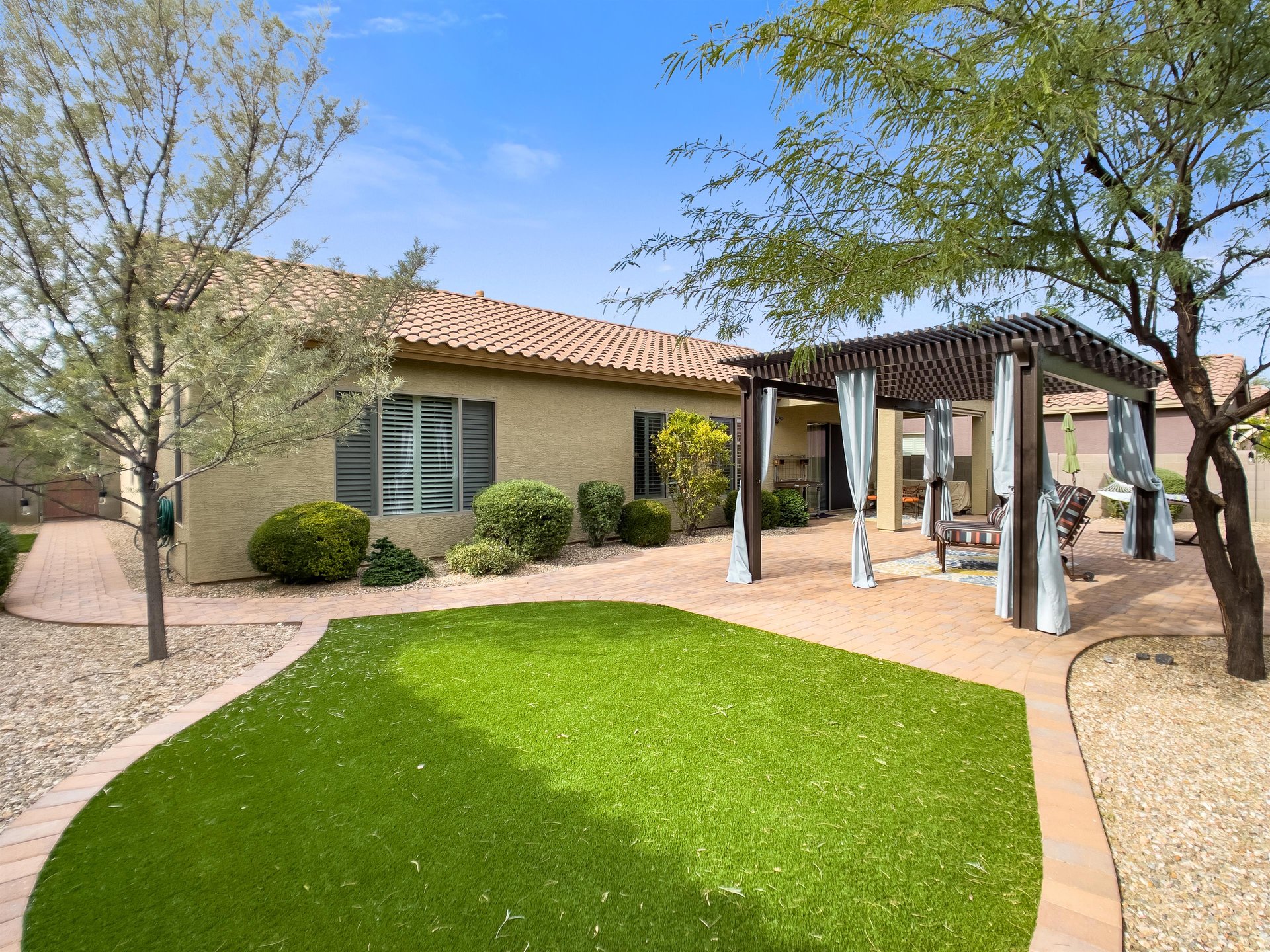 Private backyard with outdoor grill.