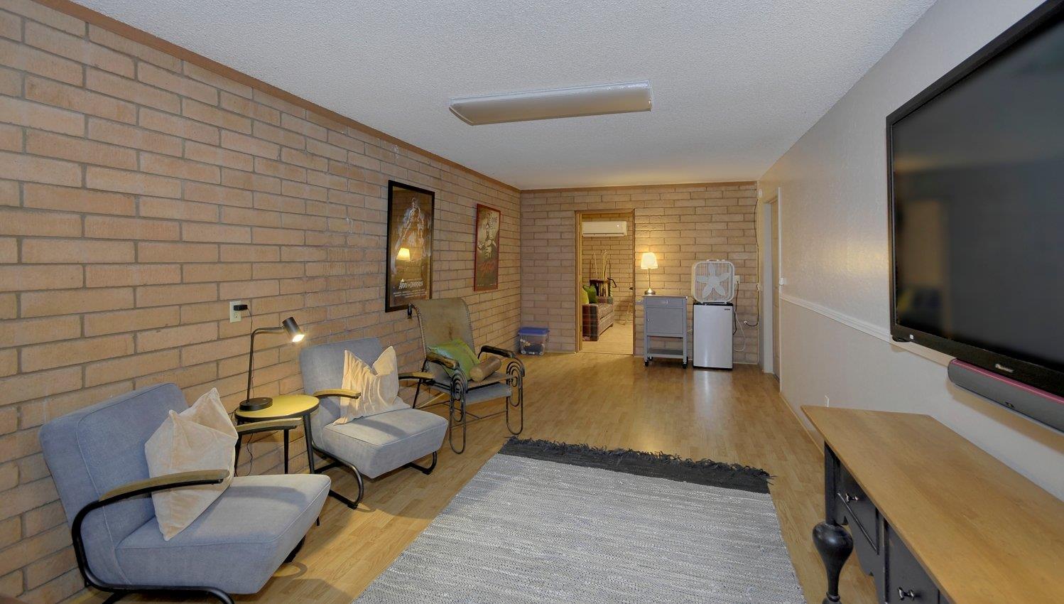 Movie room with huge TV and mini fridge